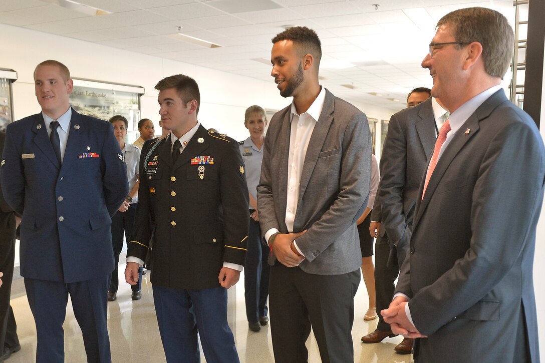 Vice Chairman of the Joint Chiefs of Staff Gen. Paul Selva takes a few moments to thank Airman 1st Class Spencer Stone, Specialist Alek Skarlatos and civilian Anthony Sadler as Secretary of Defense Ash Carter looks on prior to an awards ceremony Sept. 17, 2015, in the Pentagon's courtyard honoring them for their heroic actions in stopping a gunman on a Paris-bound train outside of Brussels last month. DoD Photo by Glenn Fawcett (Released)