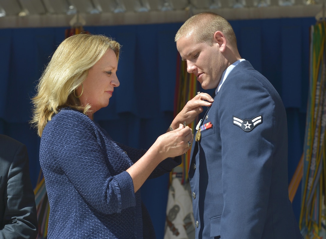 Air Force Secretary Deborah Lee James pins the Purple Heart onto Air Force Airman 1st Class Spencer Stone during a ceremony at the Pentagon Sept. 17, 2015, honoring him for his role in stopping a gunman on a Paris-bound train outside of Brussels last month. DoD Photo by Glenn Fawcett