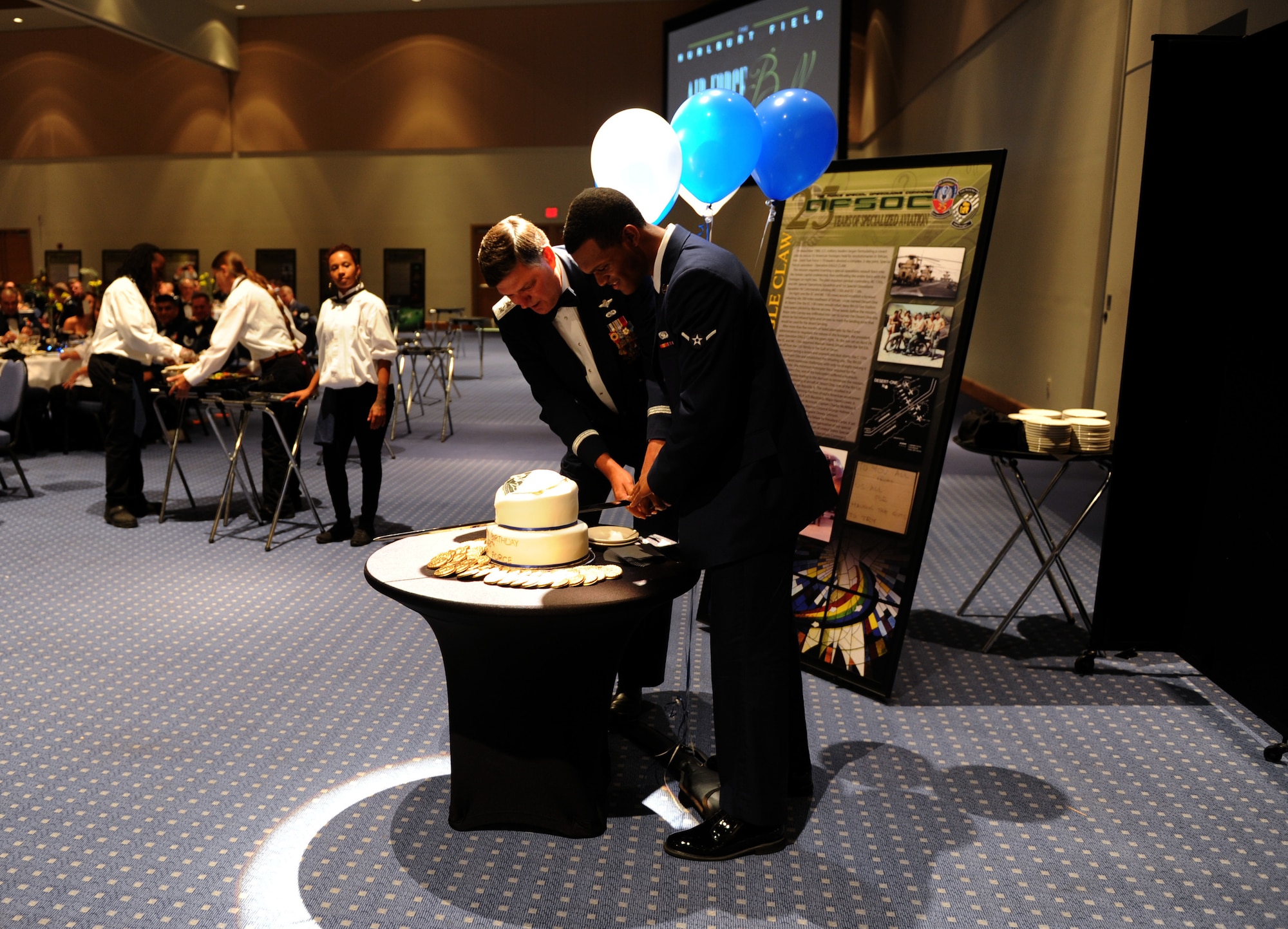Gen. Bradley Heithold, Air Force Special Operations command commander, and Airman Joshua White, 1st Special Operations Logistics Squadron logistics planner, cut the ceremonial Air Force Birthday cake during an Air Force Ball at the Emerald Coast Convention Center, Ft. Walton Beach, Fla., Sept. 12, 2015. Hosted by the 1st Special Operations Wing, more than 900 Air Force Ball attendees celebrated the high standards set by yesterday's Airmen through dedication to duty and innovation to succeed, today's diverse Airmen who stand ready to fly, fight and win against worldwide threats in air, space and cyberspace, and tomorrow's Airmen who will succeed through capability and flexibility in a future of unpredictability. (U.S. Air Force Photo by Staff Sgt. Katherine Holt)