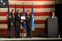 Col. Sean Farrell, 1st Special Operations Wing commander, and Chief Master Sgt. Corey Olsen, 1st SOW command chief, present retired Gen. Norty Schwartz, 19th Chief of Staff of the Air Force, with a certificate of donation in his name to the Air Commando Association during an Air Force Ball at the Emerald Coast Convention Center, Ft. Walton Beach, Fla., Sept 12, 2015. Hosted by the 1st Special Operations Wing, Air Force Ball attendees celebrated the high standards set by yesterday's Airmen through dedication to duty and innovation to succeed, today's diverse Airmen who stand ready to fly, fight and win against worldwide threats in air, space and cyberspace, and tomorrow's Airmen who will succeed through capability and flexibility in a future of unpredictability. (U.S. Air Force Photo by Staff Sgt. Katherine Holt)