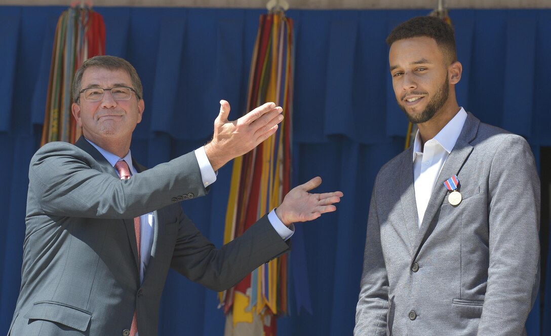 Secretary of Defense Ash Carter gestures toward Anthony Sadler during a Pentagon ceremony honoring him for his role in stopping a gunman on a Paris-bound train outside of Brussels, Sept. 17, 2015. DoD Photo by Glenn Fawcett