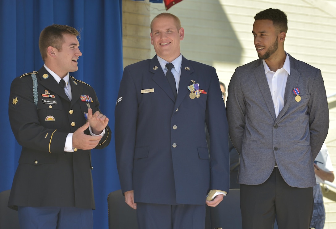 From left, Air Force Specialist Alek Skarlatos, Airman 1st Class Spencer Stone and civilian Anthony Sadler look to each other at the conclusion of a ceremony honoring them for their heroic actions in stopping a gunman on a Paris-bound train outside of Brussels last month, at the Pentagon, Sept. 17, 2015,. DoD Photo by Glenn Fawcett 