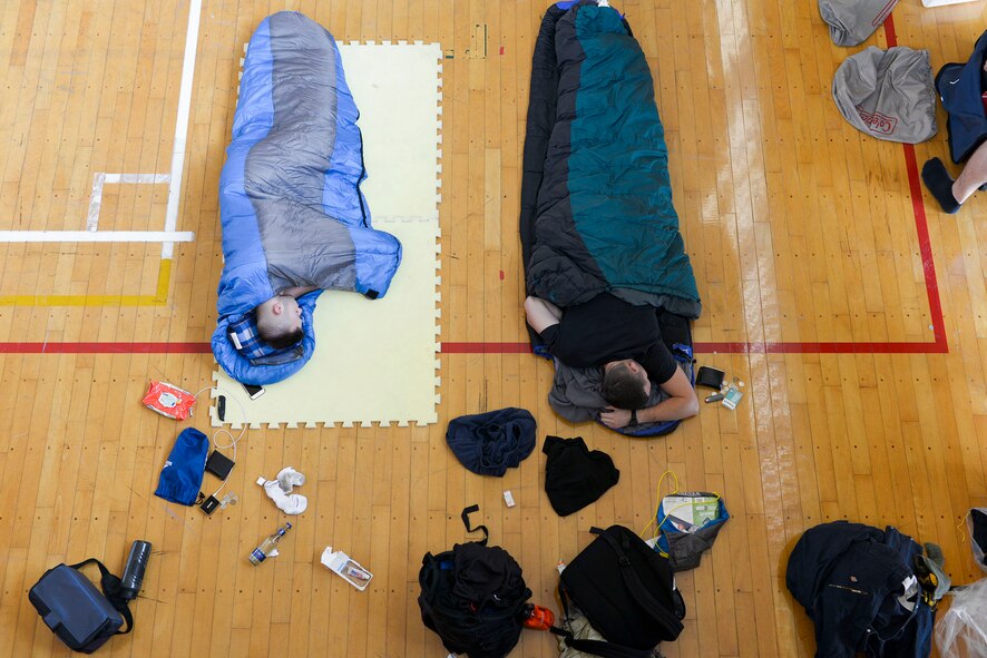 Volunteers with the 374th Civil Engineer Squadron sleep on the gym floor of a local elementary school at Kanuma City, Tochigi prefecture, Japan, Sept. 15, 2015. More than 20 of 60 volunteers stayed in the elementary's gym for two nights while assisting in flood relief efforts in the Tochigi area. (U.S. Air Force photo by Staff Sgt. Cody H. Ramirez/Released)