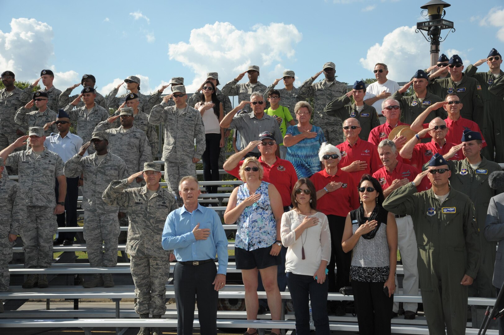 Members of Joint Base San Antonio-Randolph salutes during the Prisoners of War and Missing in Action retreat ceremony Sept. 17, 2015.  Each year these ceremonies are hosted at the Missing Man Monument. On this day, Americans across the United States pause to remember the sacrifices and service of those who were prisoners of war, as well as those who are missing in action and their families.  (U.S. Air Force photo by Joel Martinez/Released)

