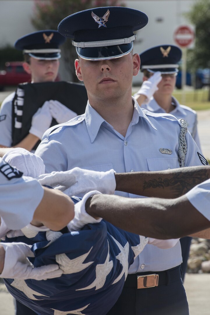 Senior Airman Joshua Schoen, Joint Base San Antonio Honor Guard member, folds the United States Flag during a POW/MIA retreat ceremony Sept. 17, 2015, at JBSA-Randolph. National POW/MIA Recognition Day is observed nationwide on the third Friday of September every year. During this time, all military installations fly the National League of Families’ POW/MIA flag, symbolizing the nation’s remembrance of those who were captured and imprisoned during war-time operations and those who still remain missing.