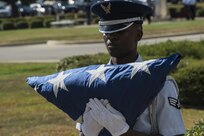 Senior Airman Willie Muhammad, Joint Base San Antonio Honor Guard member, carries the United States Flag during a POW/MIA retreat ceremony Sept. 17, 2015, at JBSA-Randolph. National POW/MIA Recognition Day is observed nationwide on the third Friday of September every year. During this time, all military installations fly the National League of Families’ POW/MIA flag, symbolizing the nation’s remembrance of those who were captured and imprisoned during war-time operations and those who still remain missing.