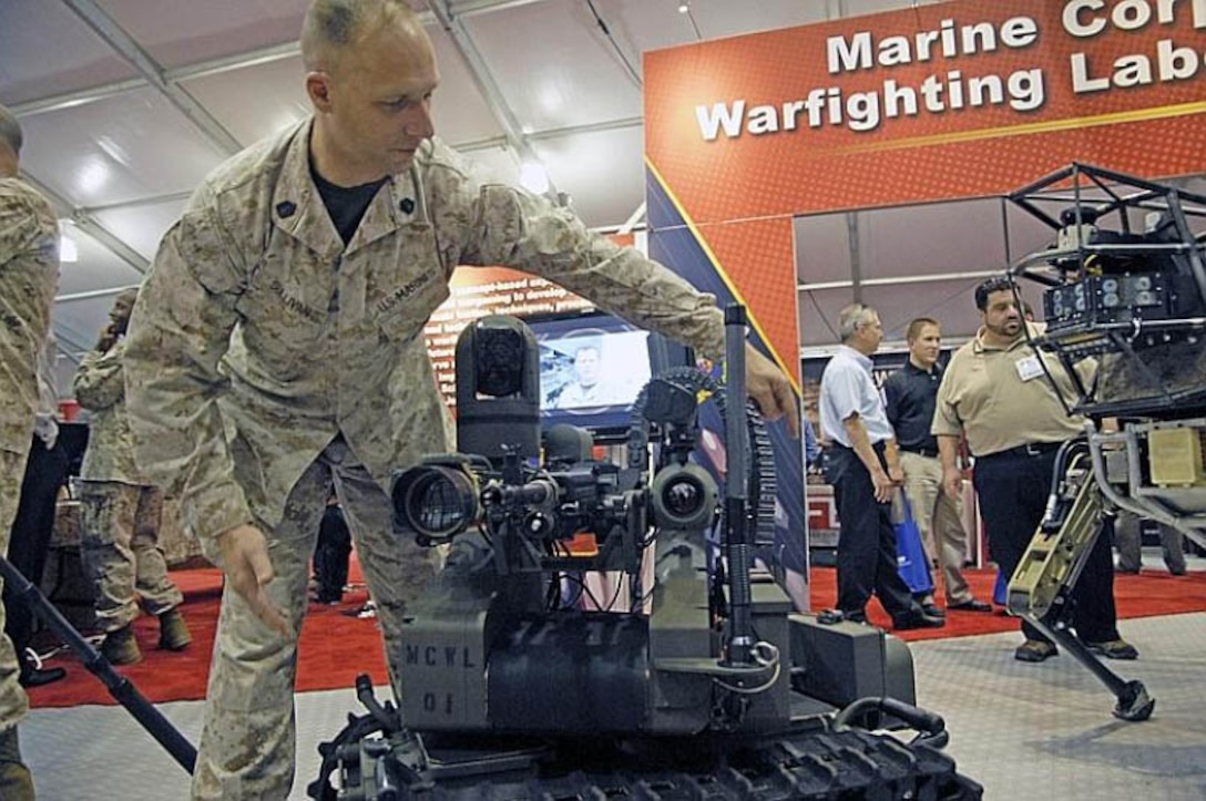 Gunnery Sgt. Steven C. Sullivan talks about how the remote-controlled Modular Advanced Armed Robotic System (MAARS) is being tested to augment machine gunners or act as a sentry or scout. The Marine Corps Warfighting Lab was displaying the robot at the Modern Day Marine convention in Quantico on Sept. 26, 2012.