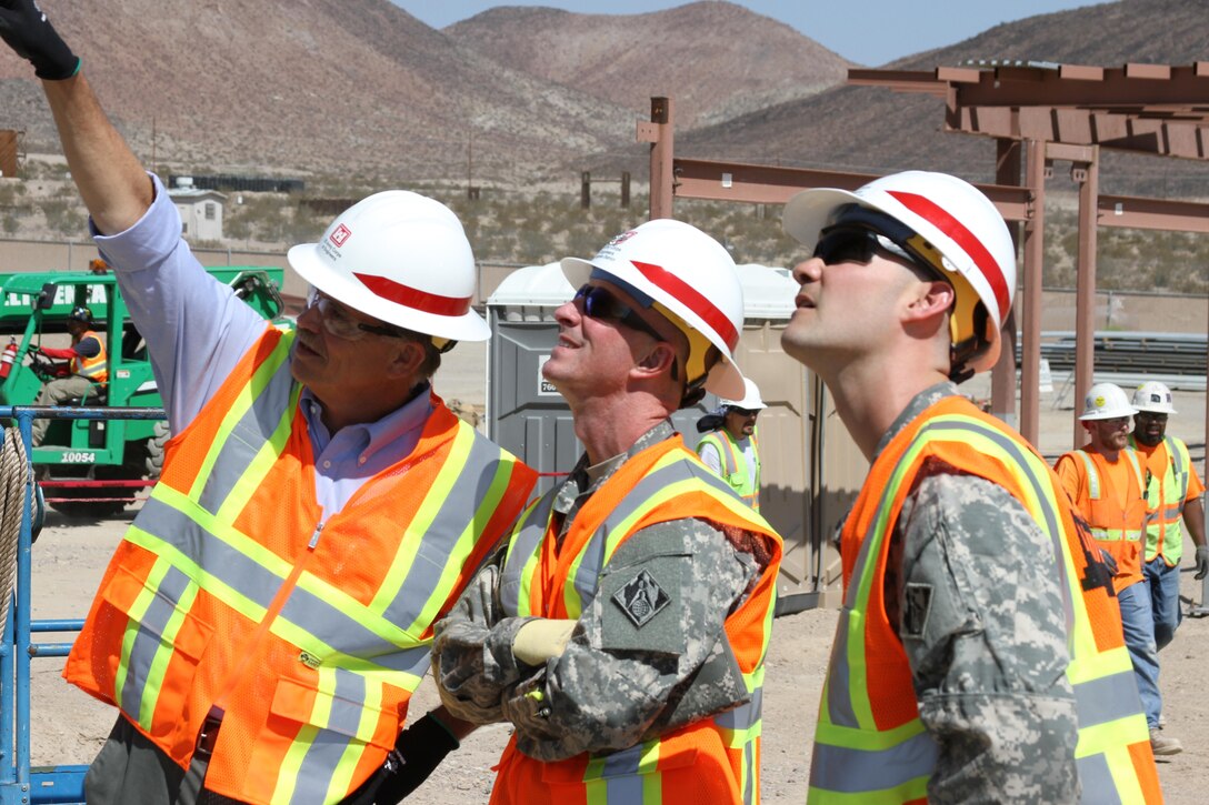 Col. Kirk Gibbs, U.S. Army Corps of Engineers Los Angeles District commander,John Keever, USACE Los Angeles District chief of construction, and Capt. Evan Nelson, project engineer discuss design features at the Weed Army Hospital replacement project site.  Gibbs, toured several District projects at the National Training Center at Fort Irwin, California, during a visit to the fort Sept. 9-10. 
