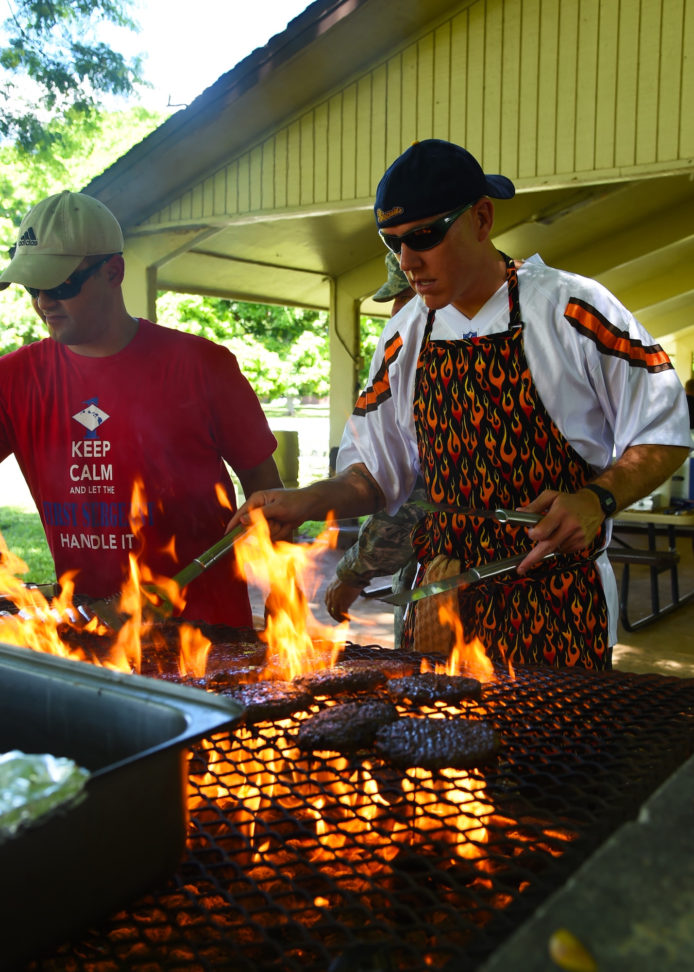 Master Sgt. Paul Weyandt, 792nd Intelligence Squadron first sergeant, (left) Master Sgt. Kurt Ward, 25th Air Support Operations Squadron first sergeant, prepare hamburgers during the Airmen’s Fall Fest at Vossler Park on Joint Base Pearl Harbor-Hickam, Hawaii, Sept. 17, 2015. In its first year, the Fall Fest featured the Pacific Air Force Band, a variety of games, Alcohol and Drug Abuse Prevention & Treatment sponsored drunk goggles go cart races, Football toss, wheel of fortune, and the commanders relay challenge. (U.S. Air Force photo by Tech. Sgt. Aaron Oelrich/Released)   