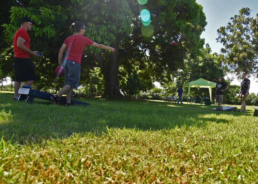 Airmen play corn-hole during the during the Airmen’s Fall Fest at Vossler Park on Joint Base Pearl Harbor-Hickam, Hawaii, Sept. 17, 2015. In its first year, the Fall Fest featured the Pacific Air Force Band, a variety of games, Alcohol and Drug Abuse Prevention & Treatment sponsored drunk goggles go cart races, Football toss, wheel of fortune, and the commanders relay challenge. (U.S. Air Force photo by Tech. Sgt. Aaron Oelrich/Released)         