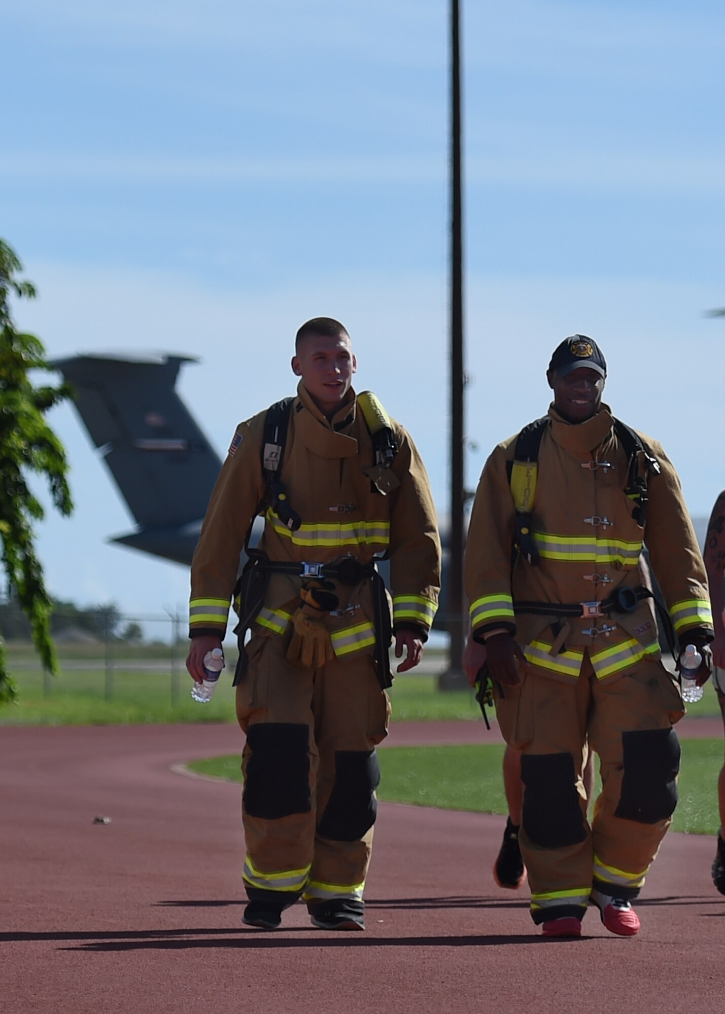 Airmen 1st Class Eli Blue (left) and Staff Sgt. Jeremey Johnson from the 647th Civil Engineer Squadron walked for more than an hour in their personal protective equipment  around Earhart track during the 24 hour Prisoner of War and Missing In Action remembrance run on Joint Base Pearl Harbor-Hickam, Hawaii, Sept. 17, 2015. The 24 hour POW/MIA remembrance run was organized by the 25th Air Support Operations Squadron as a part of POW/MIA week and National POW/MIA Day. Every year the nation pauses on the third Friday of September to remember the sacrifices and service of prisoners of war. There are 83,344 Americans still unaccounted-for across the Defense Department. (U.S. Air Force photo by Tech. Sgt. Aaron Oelrich/Released)   