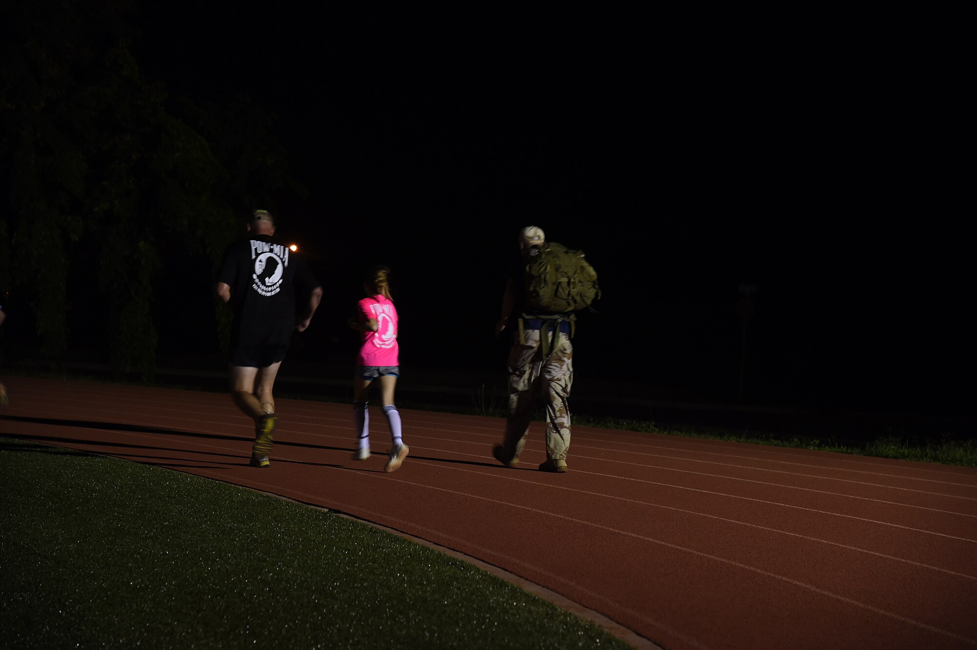 Airmen and family members run during the 24 hour Prisoner of War and Missing In Action remembrance run on Joint Base Pearl Harbor-Hickam, Hawaii, Sept. 17, 2015. The 24 hour POW/MIA remembrance run was organized by the 25th Air Support Operations Squadron as a part of POW/MIA week and National POW/MIA Day. Every year the nation pauses on the third Friday of September to remember the sacrifices and service of prisoners of war. There are 83,344 Americans still unaccounted-for across the Defense Department. (U.S. Air Force photo by Tech. Sgt. Aaron Oelrich/Released)   