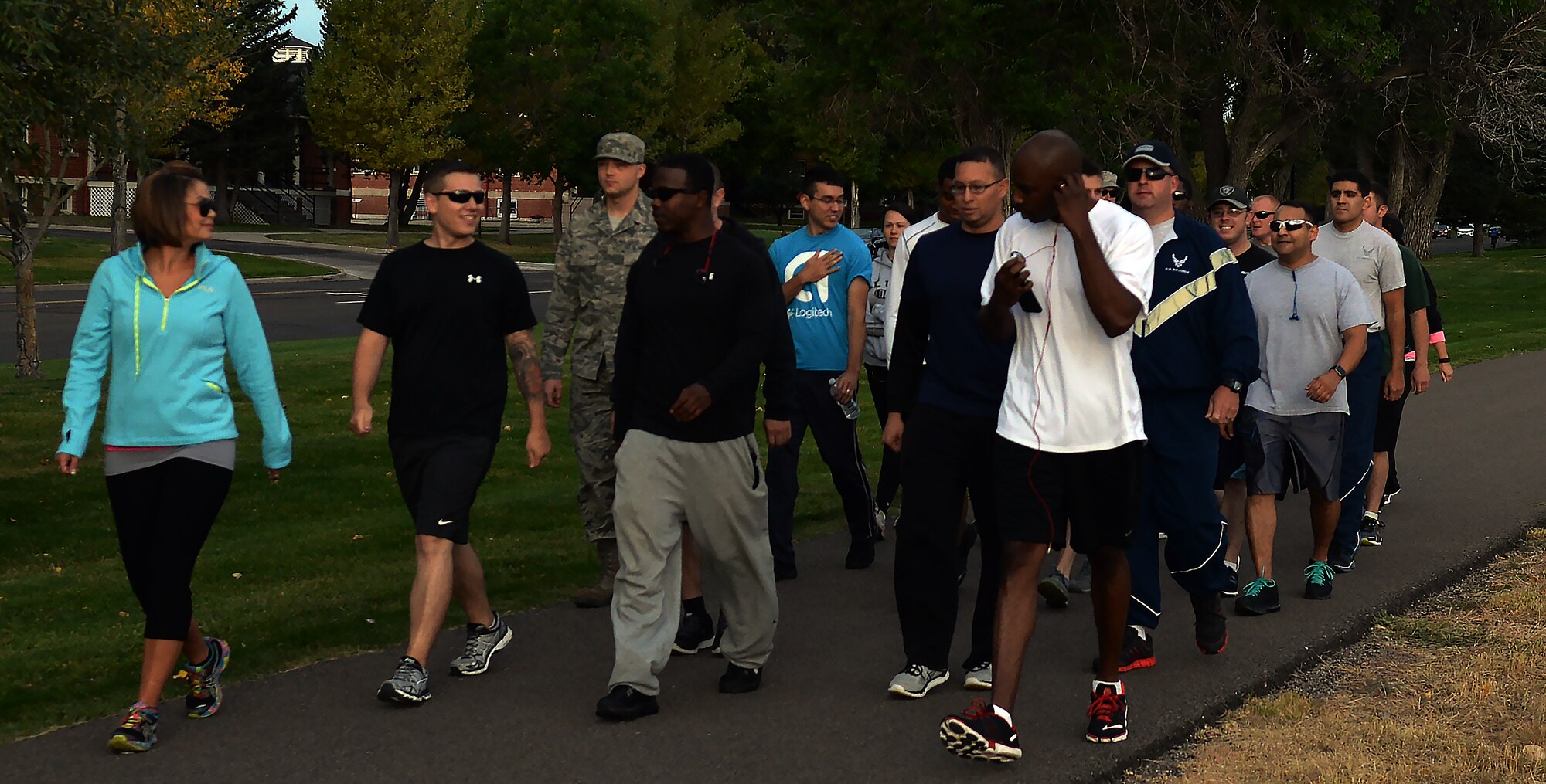 Chief Master Sgt. Clayton Lowry, 90th Force Support Squadron superintendent, carries the American flag while Col. Frank Verdugo, 90th Mission Support Group commander, carries the Prisoners of War/Missing in Action flag Sept. 16, 2015, during the 2015 POW/MIA Memorial Walk and Vigil on the Argonne Parade Field on F.E. Warren Air Force Base, Wyo. Different Airmen volunteers carried the flags from 7:30 a.m. to 4:30 p.m., passing off the flags every half hour. (U.S. Air Force photo by Airman 1st Class Brandon Valle)