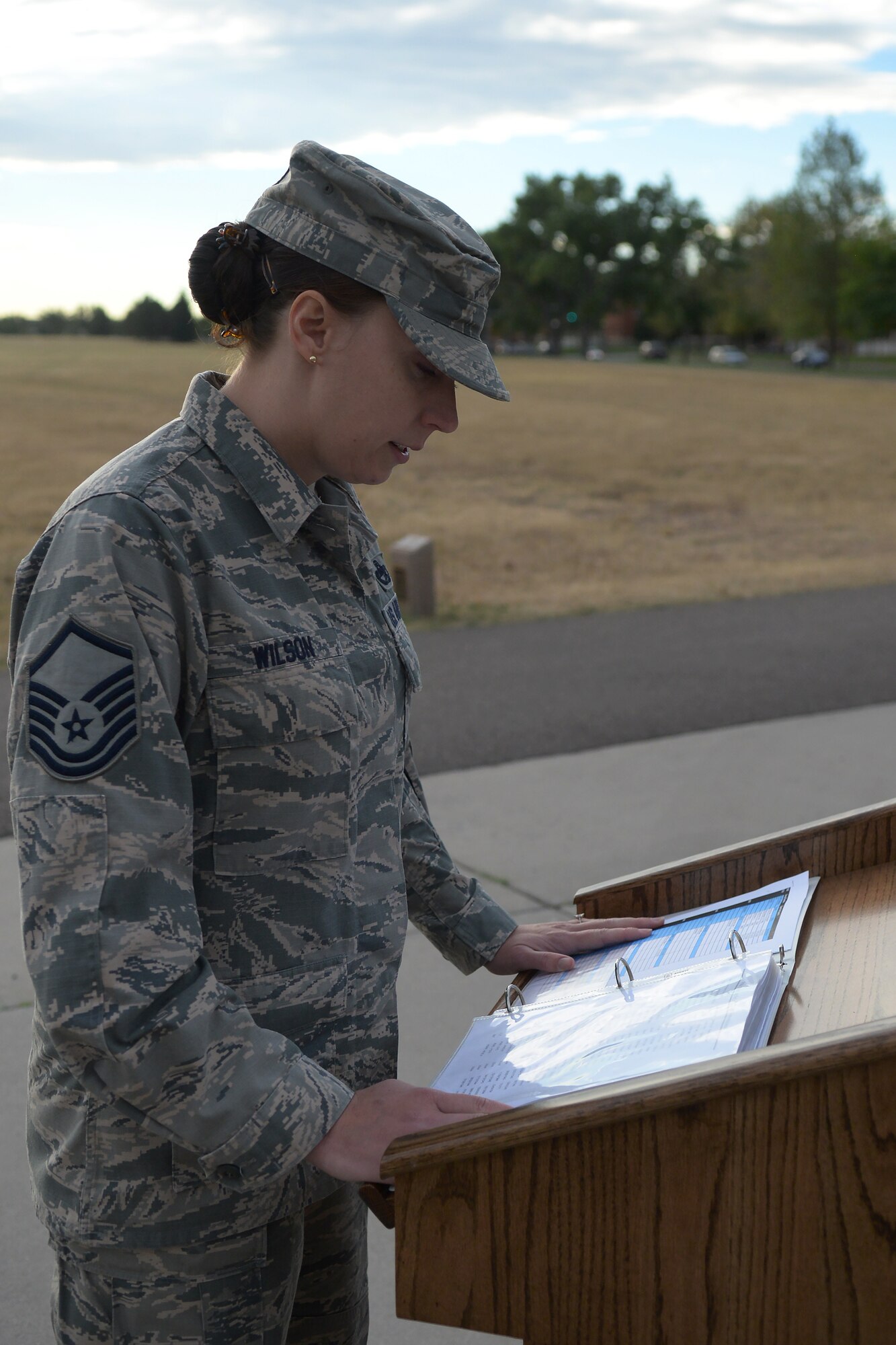 Master Sgt. Amy Wilson, 90th Logistics Readiness Squadron, reads off the names of military members who were prisoners of war or missing in action from past conflicts during the 2015 POW/MIA Memorial Walk and Vigil on the Argonne Parade Field on F.E. Warren Air Force Base, Wyo., Sept. 16, 2015. More than 90,000 men and women are still unaccounted for from World War II, the Korean War and the Vietnam Conflict. (U.S. Air Force photo by Airman 1st Class Brandon Valle)