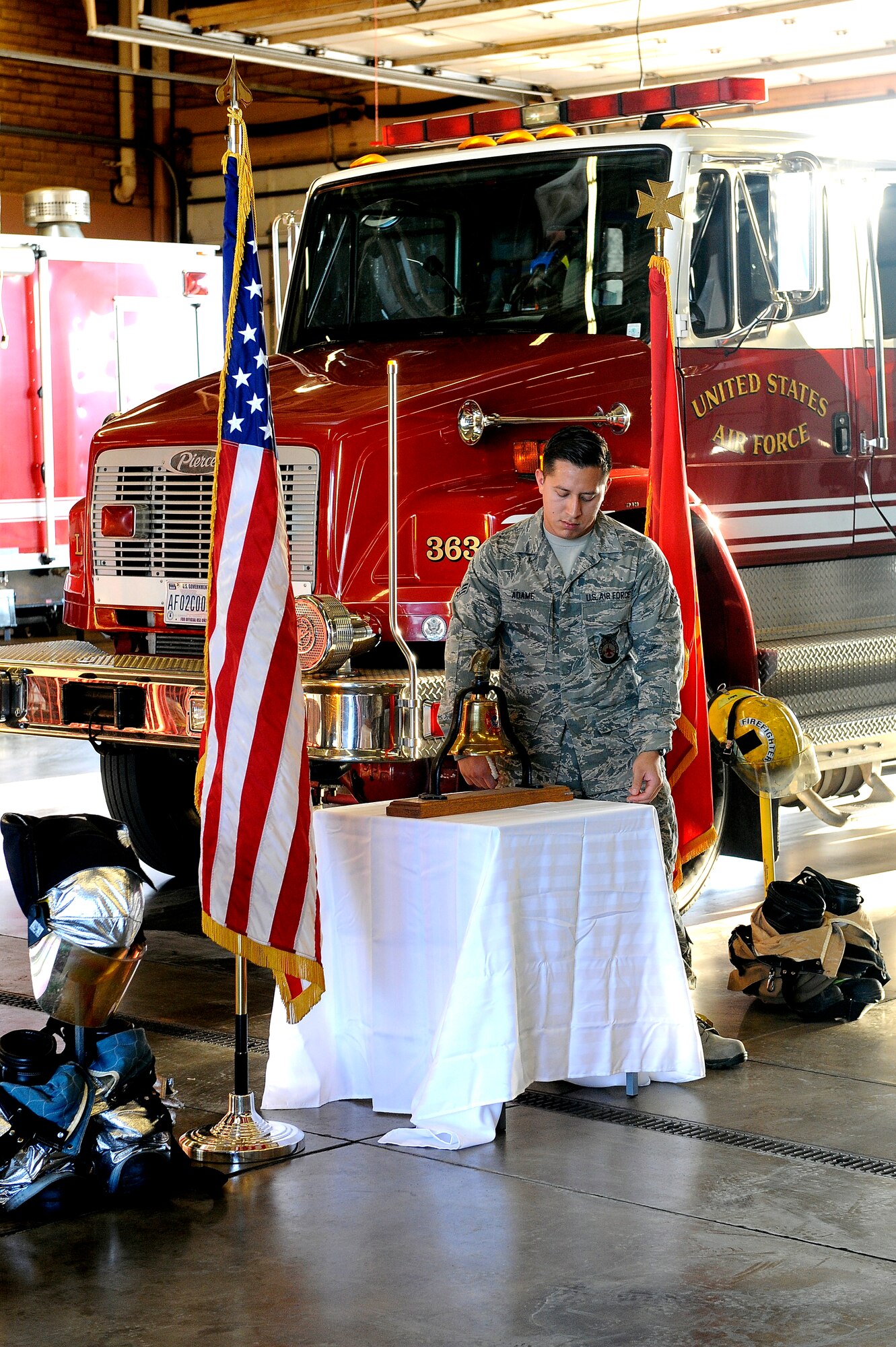 Senior Airman Oscar Adame, 56th Civil Engineer Squadron fire fighter, rings the last call bell Sept. 11, 2015 at Luke Air Force Base, Ariz. The last call bell ringing ceremony is dedicated to those firefighters that were killed in action attempting to rescuing people from the Twin Towers.  (U.S. Air Force photo by Airman 1st Class Pedro Mota)