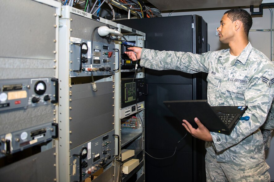 U.S. Air Force Senior Airman Dylan Wren, 23d Communications Squadron radio frequency transmissions system technician, programs a radio at the air traffic control tower Sept. 15, 2015, at Moody Air Force Base, Ga. The tactical radio work center supports land mobile radio communications with flightline personnel and emergency responders in the event of an in-flight emergency. (U.S. Air Force by Airman 1st Class Greg Nash/Released)