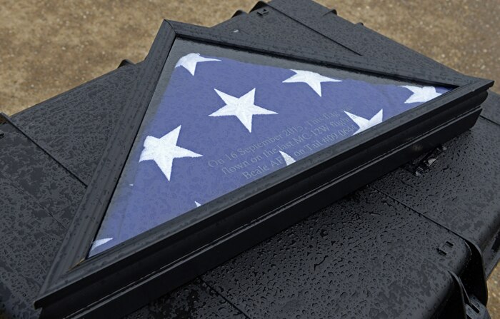 An American flag waits to be packaged and sent to the National Museum of the United States Air Force, Wright-Patterson Air Force Base, Ohio, after flying in the final flight of a MC-12W Liberty Sept. 16, 2015, at Beale Air Force Base, California. Although deployed Airmen are still supporting the mission downrange with the Army, the final flight represents Air Combat Command’s last MC-12W sortie. The MC-12W is a medium- to low-altitude, twin-engine turboprop aircraft, which provides intelligence, surveillance and reconnaissance support directly to ground forces. (U.S. Air Force photo by Airman 1st Class Ramon A. Adelan)