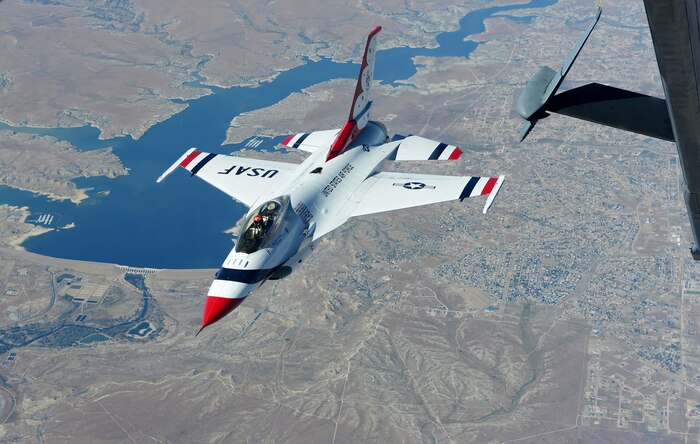 Maj. Jason Curtis, U.S Air Force Thunderbirds lead solo pilot, flies behind a KC-10 Extender Sept. 16, 2015. Curtis and the Thunderbirds demonstration team were in transit to an air show at Joint Base Andrews, Maryland. (U.S. Air Force photo by Senior Airman Bobby Cummings)