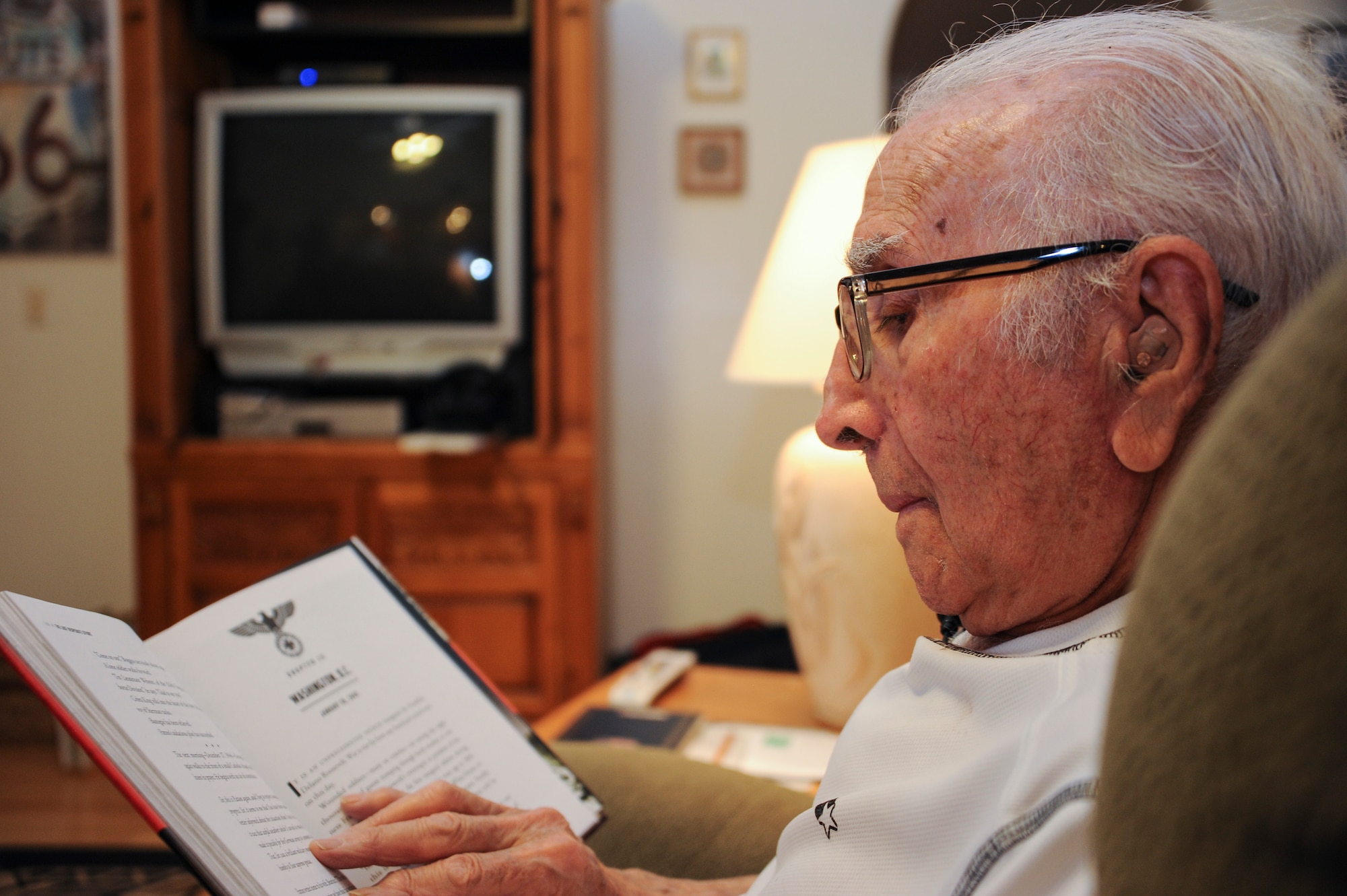 U.S. Army Pvt. Tony Gargano, World War II prisoner of war, reads a book at his place of residence in Tucson, Ariz., Sept. 10, 2015. Gargano spends his free time reading books based on WWII, gardening, and feeding birds. (U.S. Air Force photo by Airman 1st Class Ashley N. Steffen/Released)