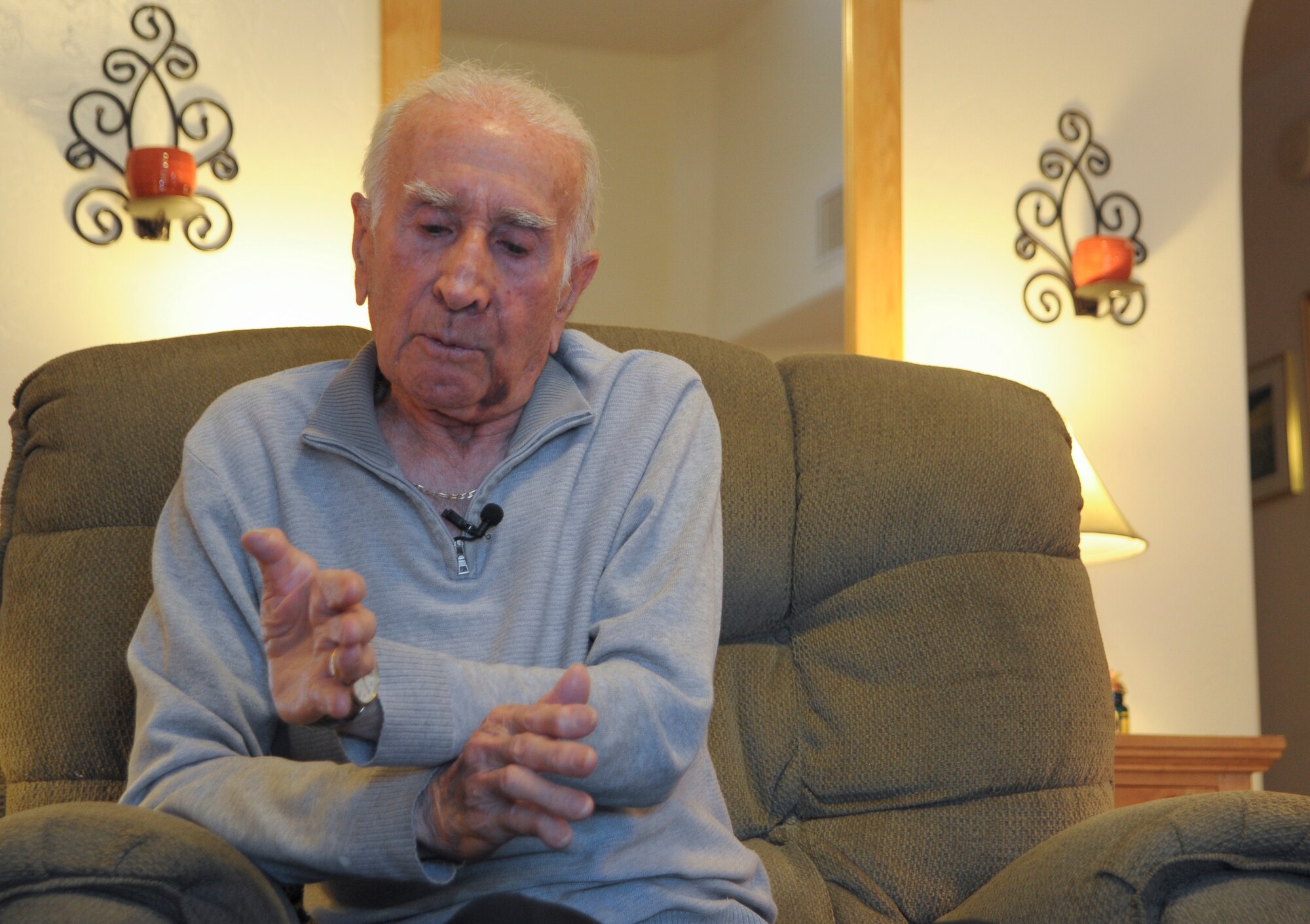 U.S. Army Pvt. Tony Gargano, World War II prisoner of war, describes a battle at his home in Tucson, Ariz., Aug. 20, 2015. Gargano was captured by German soldiers during WWII at the age of 21. (U.S. Air Force photo by Airman 1st Class Ashley N. Steffen/Released) 