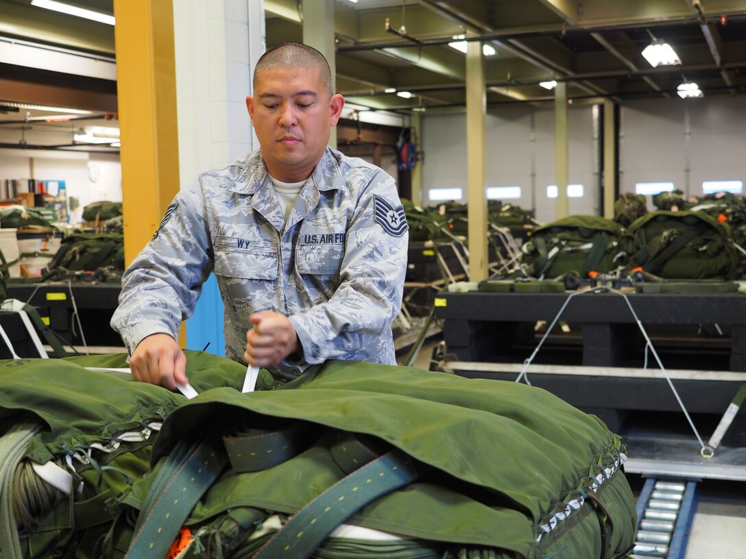 Tech. Sgt. Jerome Wy, 27th Aerial Port Squadron, completes final preparation of a 3,500 pound heavy bundle.  The bundle will be dropped during a C-130 training mission to prepare for aerial delivery of heavy equipment. (Air Force Photo by Paul Zadach/Released)