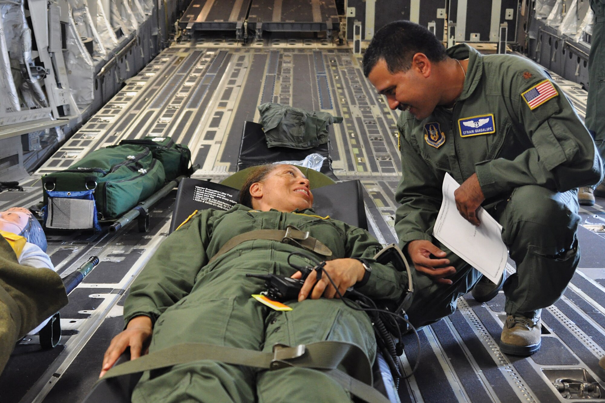 Lt. Col Kathleen Sprague and Maj. Efrain Guadalupe from the 514th Aeromedical Evacuation Squadron review a medical training scenario during a training mission Aug. 22. (U.S. Air Force photo by Senior Airman Jasmine Zielomski)