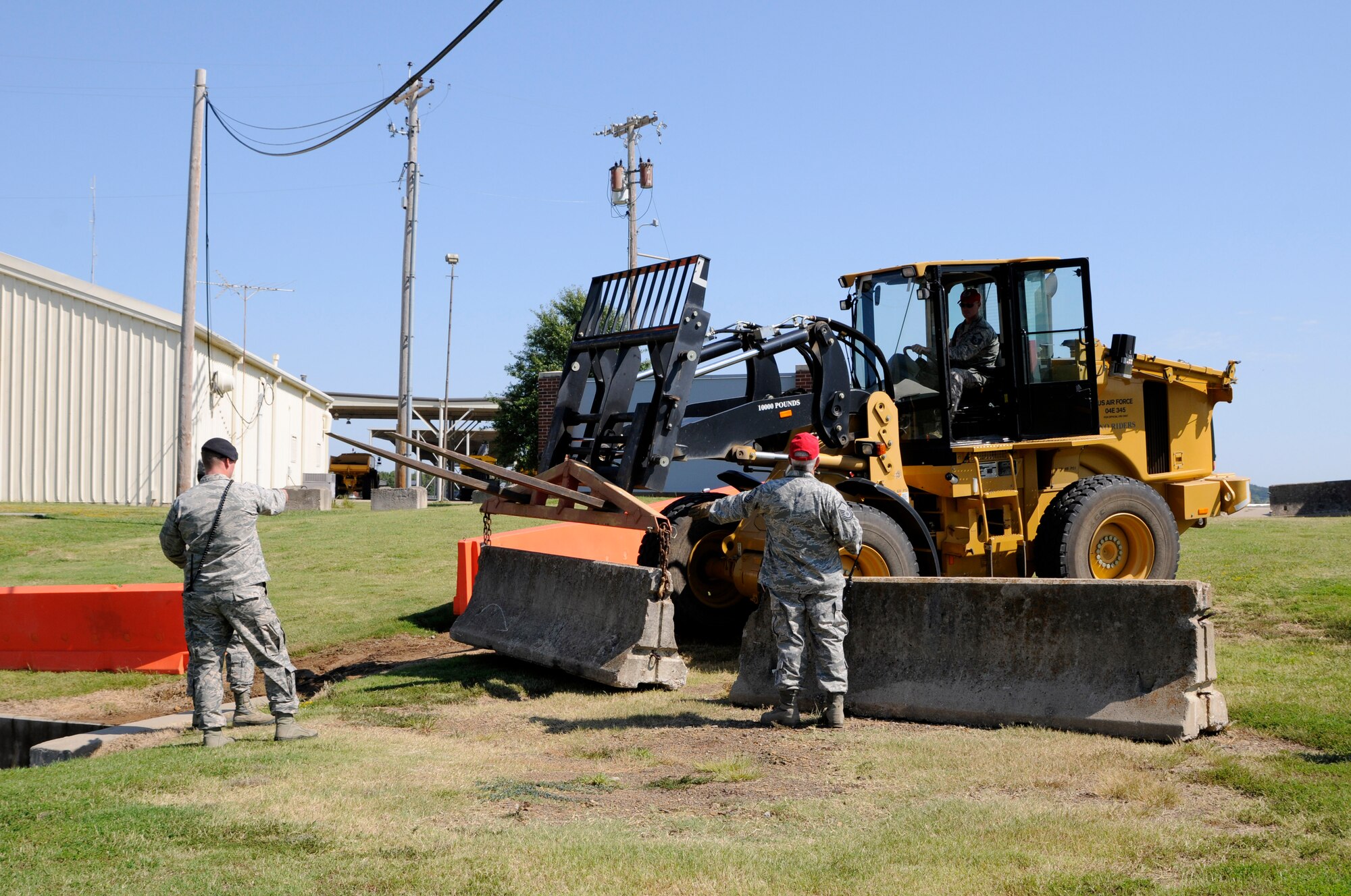 Members of the 188th Antiterrorism office and 188th Civil Engineer Squadron execute a barrier plan during an ability to survive and operate exercise held Sept. 15, 2015, at Ebbing Air National Guard Base, Ark. Ability to survive and operate exercises help strengthen the wing by assessing capabilities and assets of the force. Barriers are placed to keep all mission essential assets protected from an enemy breech. (U.S. Air National Guard photo by Staff Sgt. Hannah Dickerson/Released)