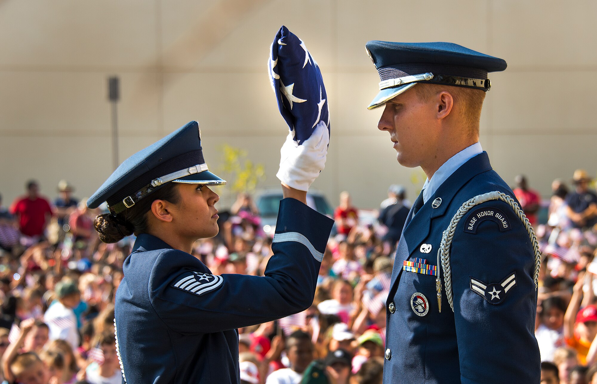 Members of the Travis Honor Guard perform a flag folding ceremony Sept. 11 during the Freedom Walk festivities at the Airman and Family Readiness Center. More than 1,000 people including students, parents, faculty and volunteers from Travis and Scandia Elementary School. (U.S. Air Force photo by T.C. Perkins Jr.)