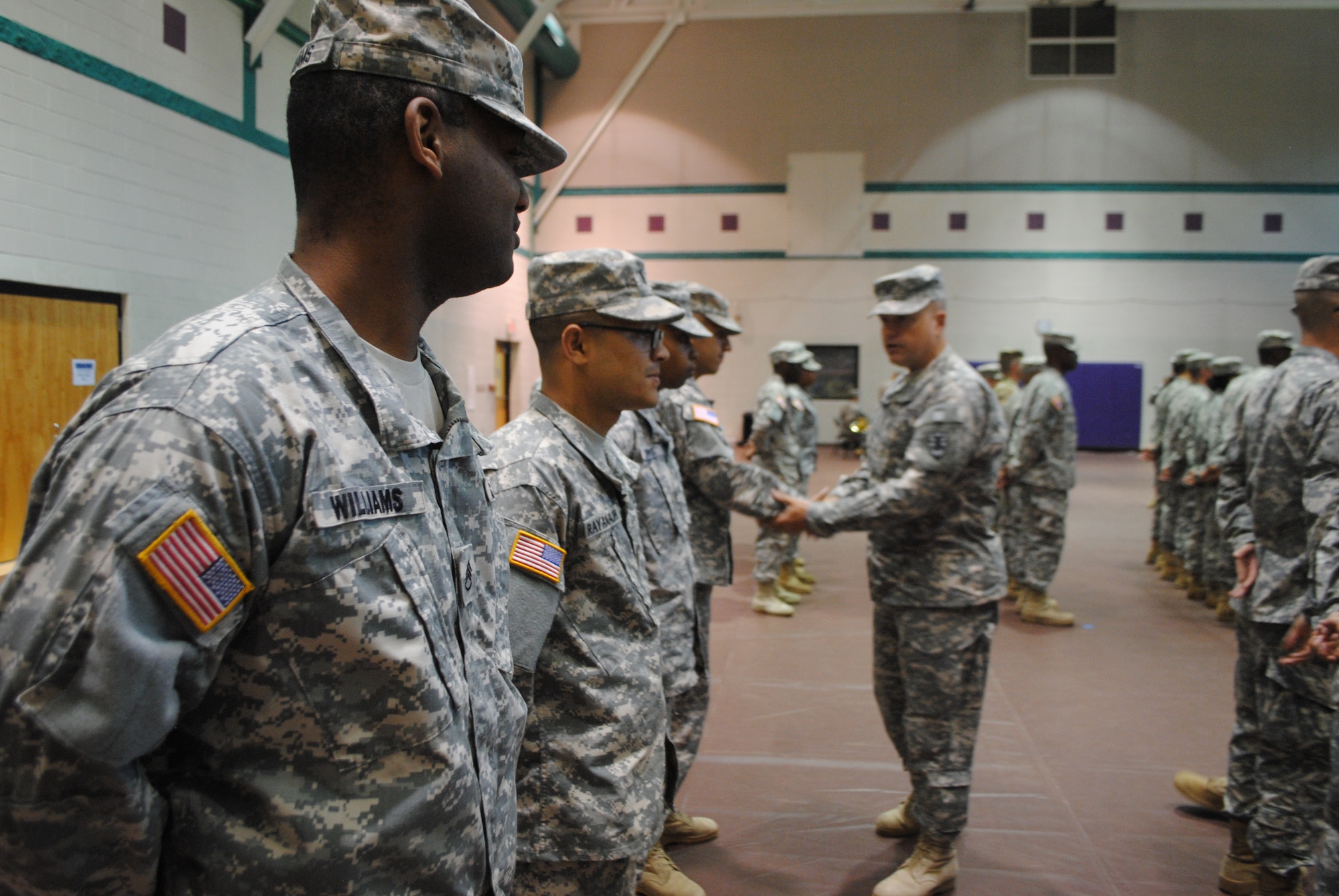 U.S. Army Soldiers with the 97th Transportation Company, 10th Trans. Battalion, 7th Trans. Brigade (Expeditionary) stand at parade rest as Col. Stacy Townsend, 7th Trans. Bde. (Ex) commander, bids them farewell during a deployment ceremony at Fort Eustis, Va., Sept. 14, 2015. The ceremony was held to honor and pay tribute to the Soldiers before deploying to an operational theater. (U.S. Army photo by 2nd Lt. Alyssa Sohn/Released)