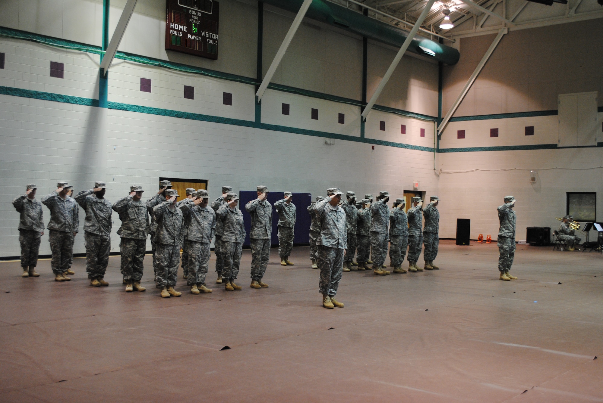 Members of the 97th Transportation Company, 10th Trans. Battalion, 7th Trans. Brigade (Expeditionary) salute during the National Anthem at their deployment ceremony at Fort Eustis, Va., Sept. 14, 2015.  After the ceremony members of the Brigade spoke individually with the soldiers wishing them well on their deployment. (U.S. Army photo by 2nd Lt. Alyssa Sohn/Released)