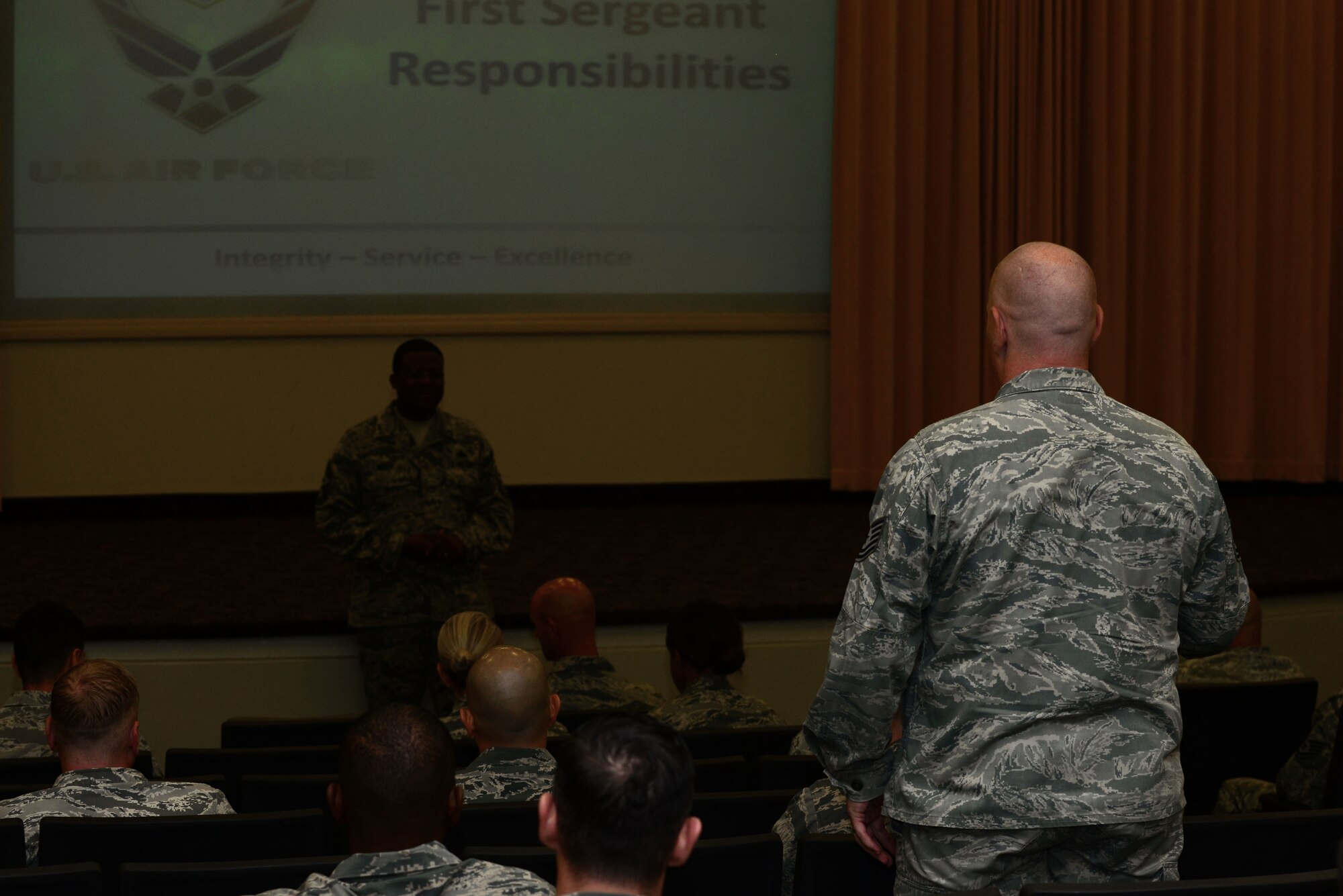 A U.S. Air Force technical sergeant directs a question to Chief Master Sgt. Henry Hayes, Headquarters Air Combat Command first sergeant, during a first sergeant symposium at Langley Air Force Base, Va., Sept. 15, 2015. Both Hayes and Chief Master Sgt. Mark Hurst, 633rd Air Base Wing command chief, answered questions to start the four-day symposium. (U.S. Air Force photo by Senior Airman Kimberly Nagle/Released)