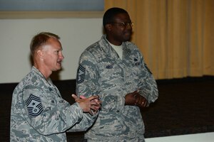 U.S. Air Force Chief Master Sgts. Mark Hurst, 633rd Air Base Wing command chief, left, and Henry Hayes, Headquarters Air Combat Command first sergeant, speak during a first sergeant symposium at Langley Air Force Base, Va., Sept. 15, 2015. The two spoke to a crowd of noncommissioned officers and senior noncommissioned officers about the importance of Air Force first sergeants. (U.S. Air Force photo by Senior Airman Kimberly Nagle/Released) 