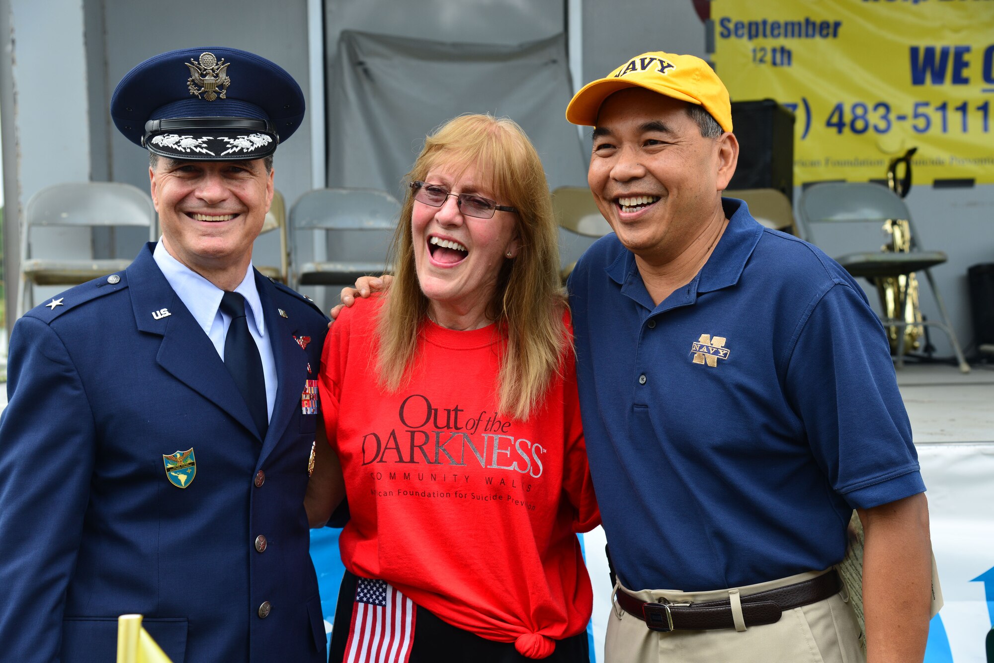 U.S. Air Force Brig. Gen. (Dr.) Sean Murphy, Command Surgeon, Headquarters Air Combat Command, Chris Gilchrist, Hampton Roads area psychotherapist and Out of the Darkness Walk event coordinator, and Commander Naval Surface Force Atlantic, Rear Adm. Peter A. Gumataotao, embrace each other prior to the start of the 10th annual Out of the Darkness Community Walk in Virginia Beach, Va., Sept. 12, 2015. For the past six years, military and local community members partnered in Hampton Roads’ participation in the nation's largest walk with 8,234 participants in 2014 and more than $244,000 raised to date. (U.S. Air Force photo by Senior Airman Aubrey White/Released)