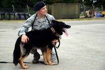 U.S. Air Force Staff Sgt. Roy Carter, 100th Security Force Squadron Military
Working Dog handler, pets MWD Luc after completing a detection sweep Sept. 8,
2015, on RAF Mildenhall, England. Carter rewarded MWD Luc for detecting an
aid. The team found all 10 aids within 40 minutes. (U.S. Air Force photo by
Senior Airman Christine Halan/Released)
