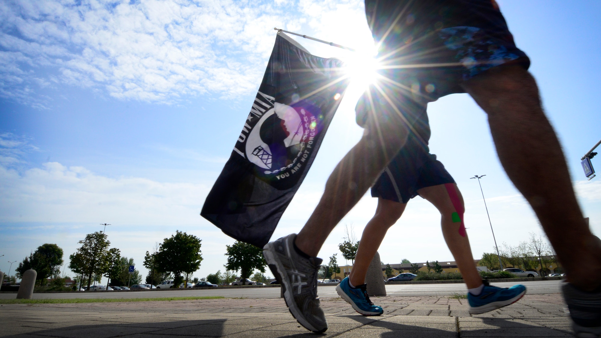 U.S. Air Force Staff Sgt. Jose Bueno, 372nd Training Squadron, Detachment 24, avionics instructor, and Staff Sgt. Amber Swearengin, 31st Mission Support Group commander support staff NCO in charge, participate in the Prisoner of War/Missing in Action memorial run, Sept. 16, 2015, at Aviano Air Base, Italy. The Air Force Sergeants Associations hosts various events leading up to National POW/MIA Recognition Day, including retreat and the table ceremony to remember fellow service members. (U.S. Air Force photo by Senior Airman Areca T. Bell/Released)