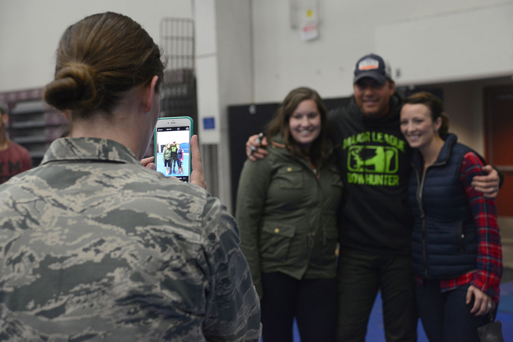 ABOVE: Fans take pictures with Rodney Atkins after a performance at the Buckner Physical Fitness Center on Joint Base Elmendorf-Richardson Sept. 15. The week-long tour in Alaska has USO-tour veterans Rodney Atkins and The Swon Brothers as they perform at Eielson Air Force Base, JBER and U.S. Coast Guard Base Kodiak. (U.S. Air Force photos/Airman 1st Class Christopher R. Morales)