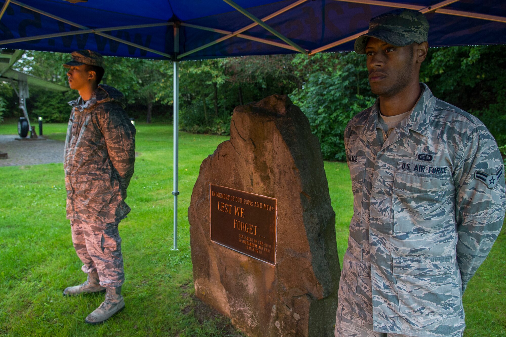 U.S. Air Force Senior Airman Bayani Olano, a 52nd Medical Support Squadron pharmacy technician, left, and U.S. Air Force Airman 1st Class Kristofer Wallace, a 52nd Communications Squadron postal clerk, stand guard at the prisoners-of-war/missing-in-action memorial on Spangdahlem Air Base, Germany, Sept. 16, 2015. Olano and Wallace volunteered to stand guard as the names of POW/MIA were read aloud. Sept. 18 marks the national POW/MIA Remembrance Day. (U.S. Air Force photo by Airman 1st Class Luke Kitterman/Released)