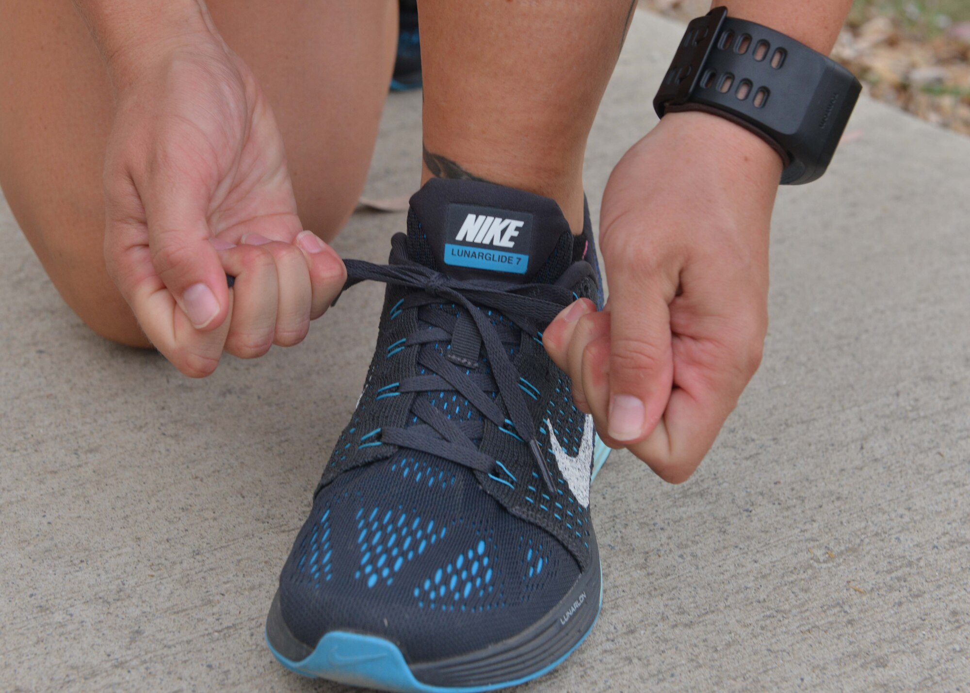 Senior Airman Mary Tarasiewicz, 39th Security Forces Squadron unit deployment manager, laces up her shoes before running Sept. 9, 2015, at Incirlik Air Base, Turkey. In addition to running the marathon, Tarasiewicz raised $500 in donations for the Air Force Enlisted Village. (U.S. Air Force photo by Senior Airman Michael Battles/Released) 
