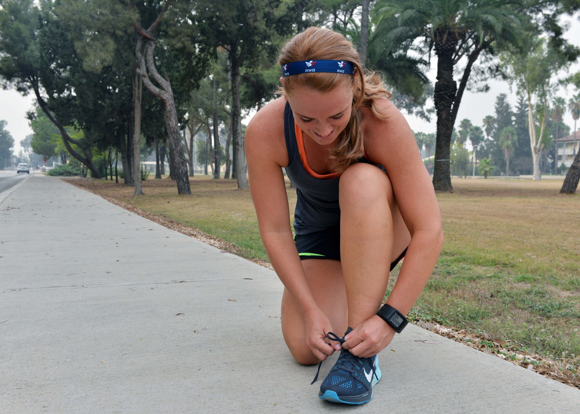 Senior Airman Mary Tarasiewicz, 39th Security Forces Squadron unit deployment manager, laces up her shoes before running Sept. 9, 2015, at Incirlik Air Base, Turkey. Tarasiewicz is sponsored to run the marathon by the Air Force Enlisted Village. (U.S. Air Force photo by Senior Airman Michael Battles/Released) 