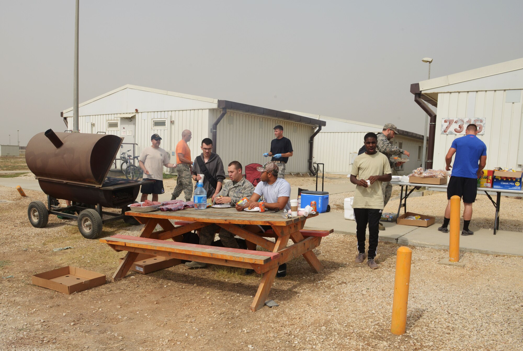 Airmen living in Patriot Village eat lunch prepared for them by Aviano and Incirlik air base first sergeants Sept. 11, 2015, at Incirlik Air Base, Turkey. The cookout was a surprise Random Acts of Kindness event held for the purpose of increasing morale in Airmen deployed to Incirlik AB.  (U.S. Air Force photo by Senior Airman Krystal Ardrey) 
