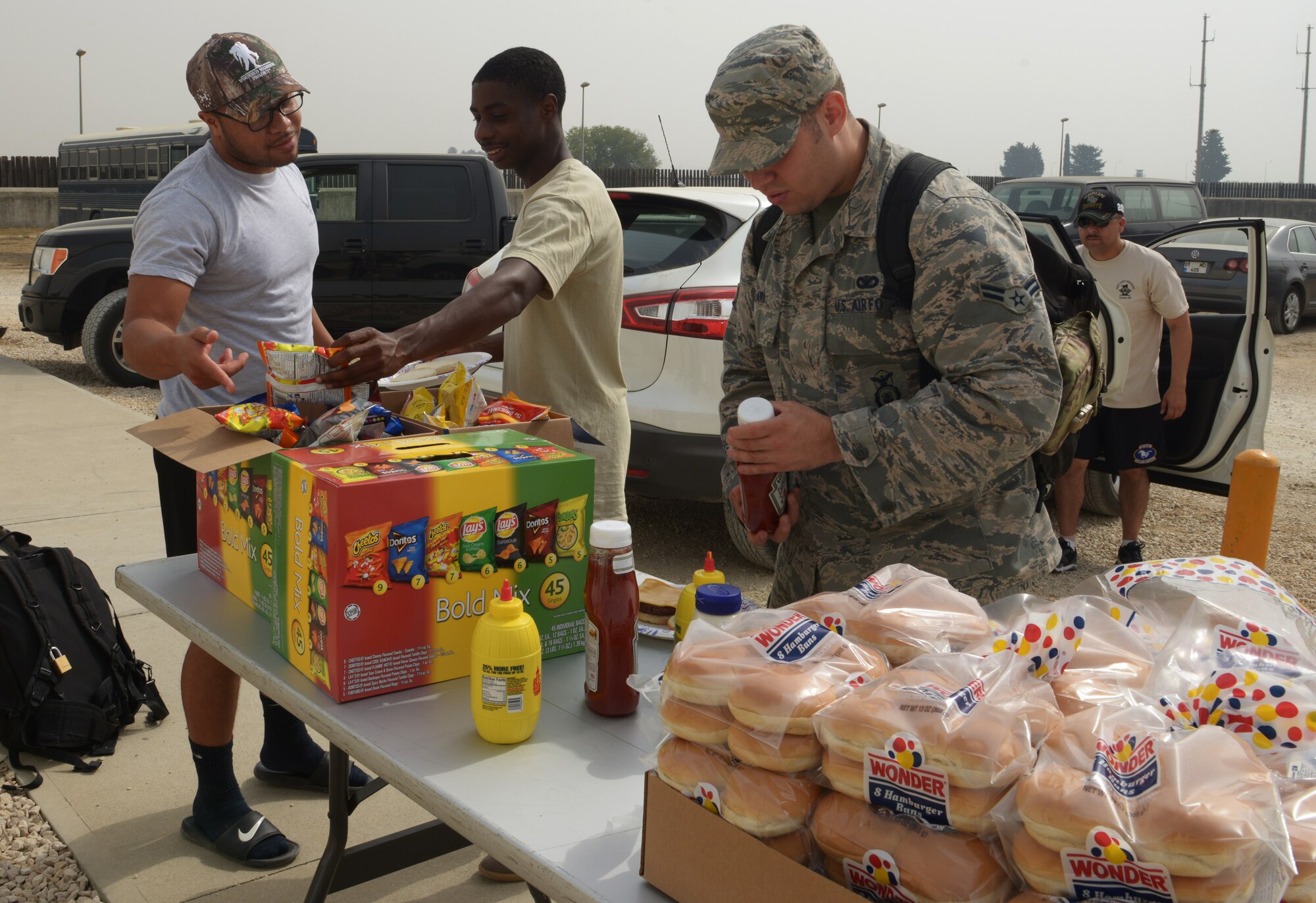 Airmen from Aviano Air Base, Italy prepare lunch that was provided for them by Aviano and Incirlik air base first sergeants at Patriot Village Sept. 11, 2015, at Incirlik Air Base, Turkey. The cookout is a surprise Random Acts of Kindness event, which is part of an ongoing program aimed at boosting morale for stationed or deployed to Incirlik AB. (U.S. Air Force photo by Senior Airman Krystal Ardrey)