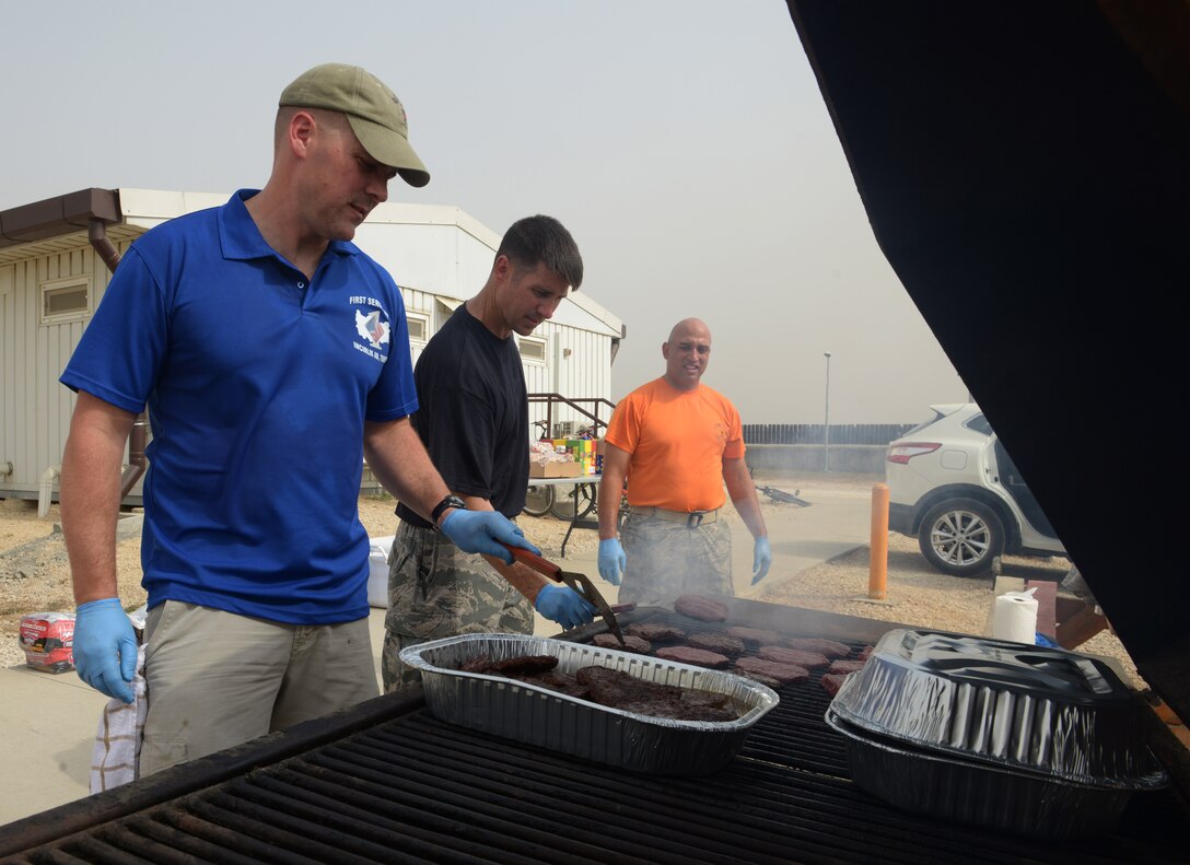 Incirlik first sergeants grill lunch for Airmen living in Patriot Village Sept. 11, 2015, at Incirlik Air Base, Turkey. The cookout is a surprise Random Acts of Kindness event, which is part of an ongoing program aimed at boosting morale for stationed or deployed to Incirlik AB. (U.S. Air Force photo by Senior Airman Krystal Ardrey) 