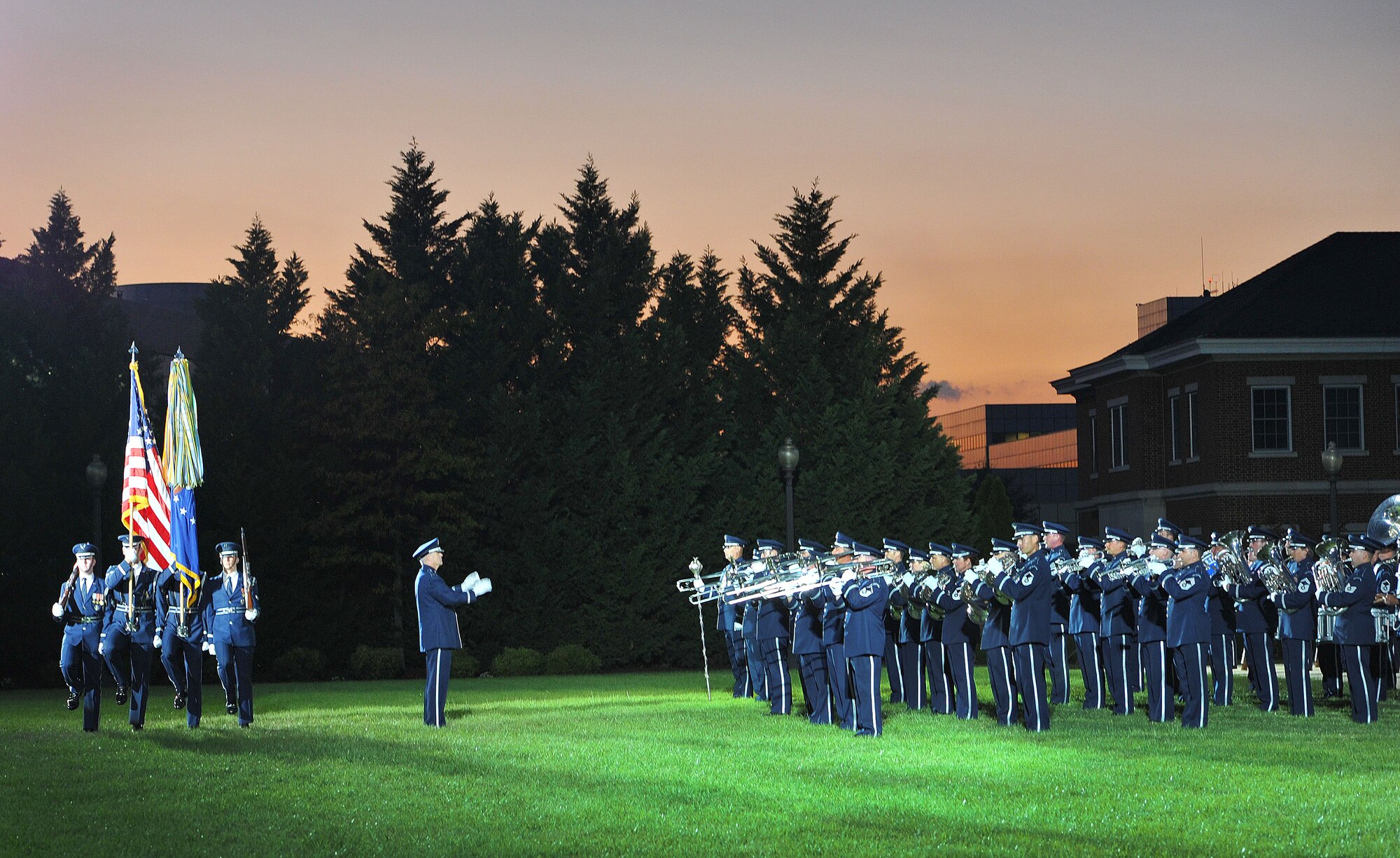 The United States Air Force Honor Guard Drill Team and Air Force Band present the colors during the United States Air Force Tattoo on Sept. 17, 2015. The Air Force District of Washington commemorated the United States Air Force's 68th birthday September 17, 2015 with a celebration of music, drill and ceremony, aircraft, and fireworks on the Air Force Ceremonial Lawn at Joint Base Anacostia-Bolling. The event included flyovers of several aircraft that included the Air Force Thunderbirds and a Warbird vintage aircraft squadron, as well as performances by the Air Force Band and Honor Guard. (U.S. Air Force photo/Jim Lotz)