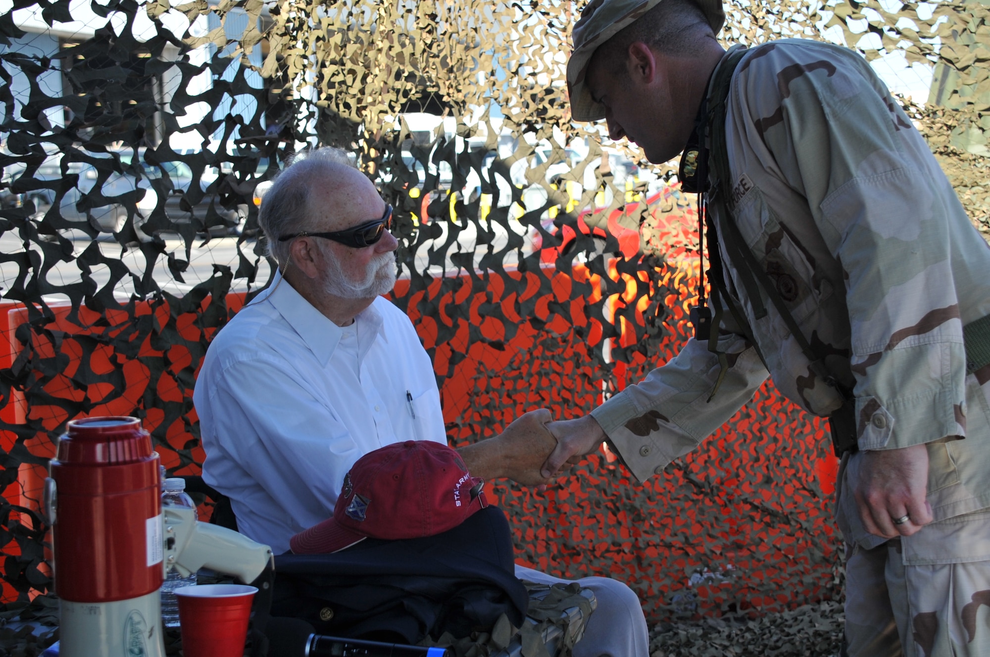 Guest speaker and retired Army 1st Lt. George Gentry, a Vietnam veteran, is coined and thanked for his service and sacrifice by Master Sgt. Zachary Pate, 61st Air Base Group 1st Sgt. during the Space and Missile Systems Center Dining Out held at Los Angeles Air Force Base in El Segundo, Calif. (U.S. Air Force photo/Sarah Corrice)