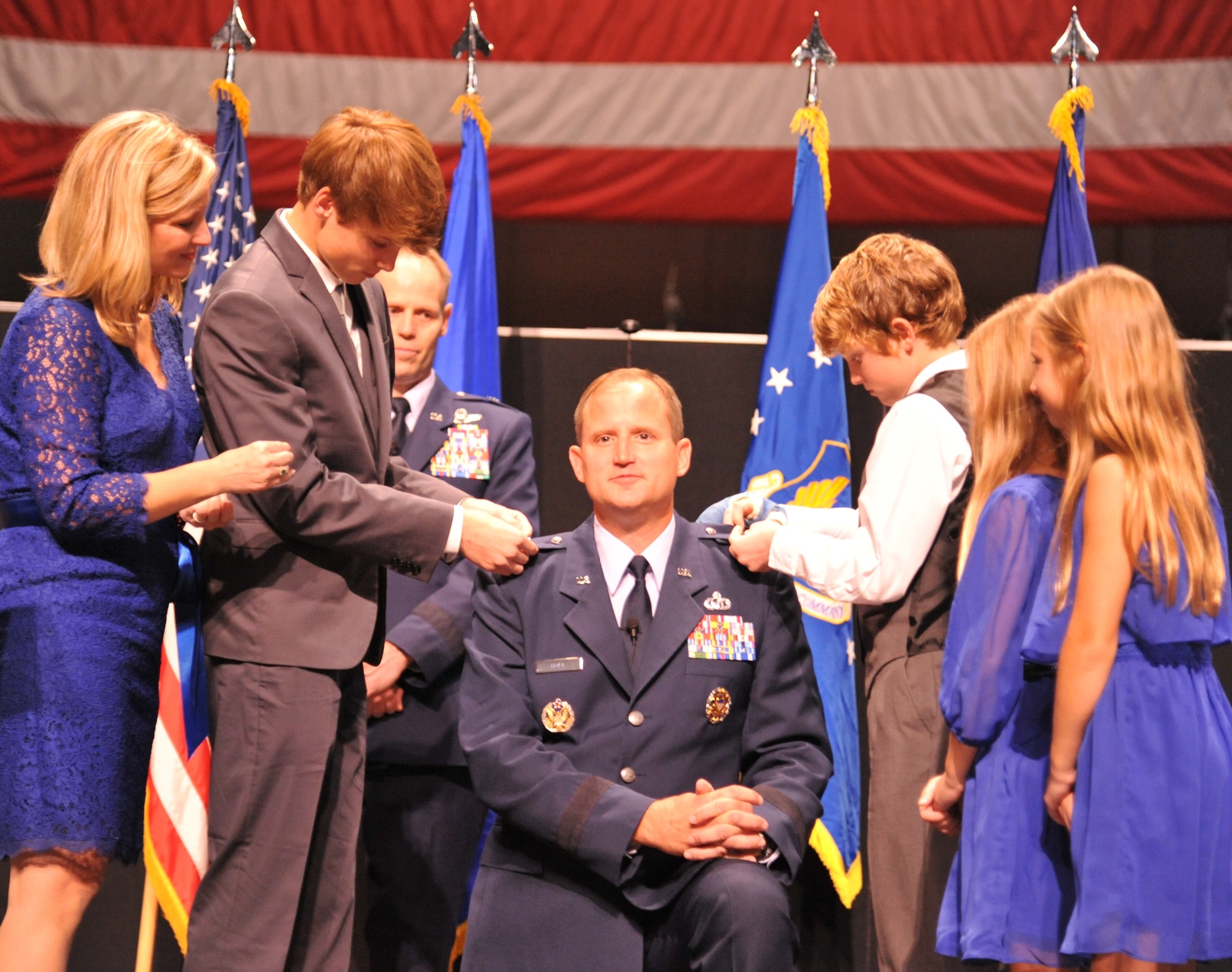 The family of Brig. Gen. Cameron Holt pins on his first star during the ceremony. (Air Force photo by Gina Marie Giardina)