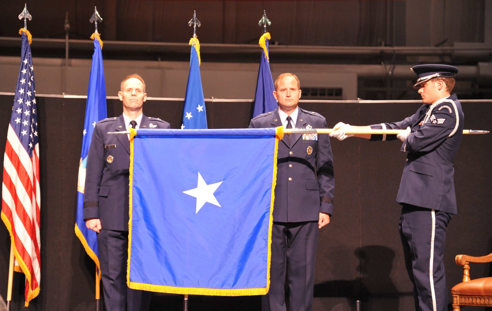 Brig. Gen. Blaine Holt, deputy, U.S. Military Representative to the North Atlantic Treaty Organization, assists with the pin-on ceremony of his younger brother, Brig. Gen. Cameron Holt, commander, Air Force Installation Contracting Agency, Air Force Installation and Mission Support Center, Air Force Materiel Command, during a ceremony Sept. 14 at the National Museum of the U.S. Air Force. (Air Force photo by Gina Marie Giardina)