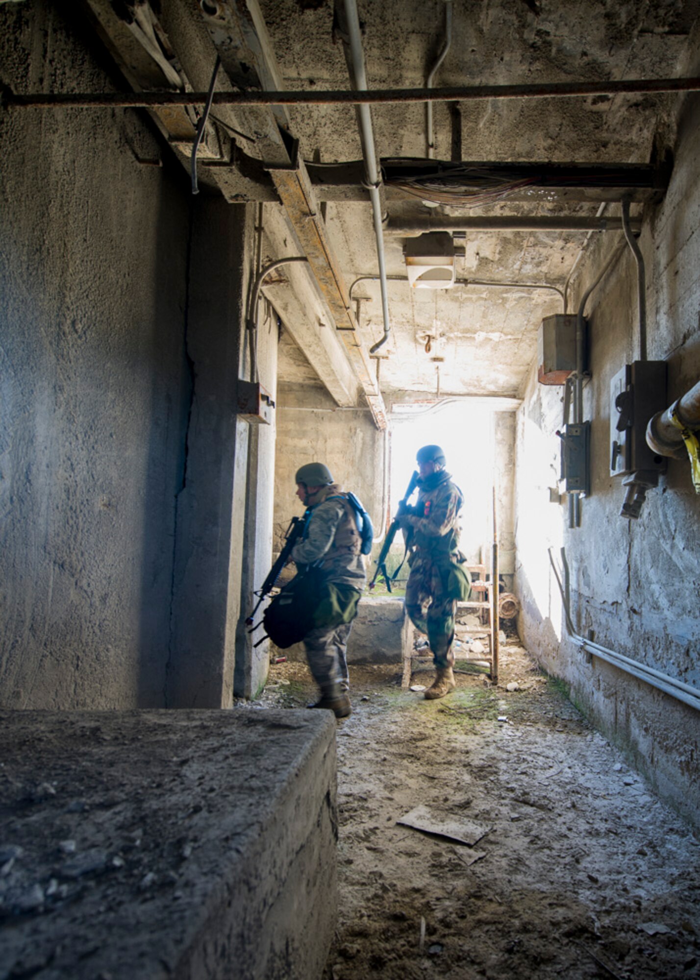 Participants in the Air Force Research Laboratory 2015 Tech Warrior exercise enter an underground tunnel area in search of a weapons cache as part of a dismounted patrol scenario Sept. 15, 2015, at the National Center for Medical Readiness, Fairborn, Ohio. During the exercise participants learned a variety of skills such as base defense, self-aide buddy care, tactical vehicle driving, and land navigation. (U.S. Air Force photo by Wesley Farnsworth / Released)