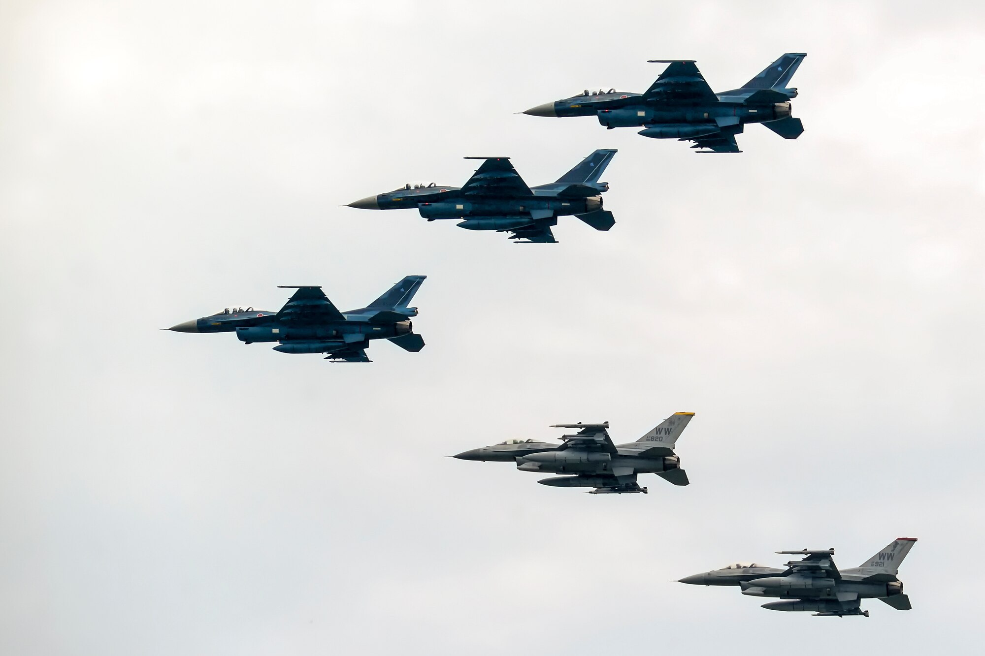 Three Japan Air Self-Defense Force F-2's and two U.S. Air Force F-16 Fighting Falcon's  fly in formation during the opening ceremony at the Misawa Air Festival Sept. 13, 2015. The festival featured more than 30 static displays, live musical performances by the Pacific Air Forces Band Pacific Trends, several food booths and aerial demonstrations. (U.S. Air Force photo by Tech. Sgt. Melissa Mekpongsatorn/Released) 