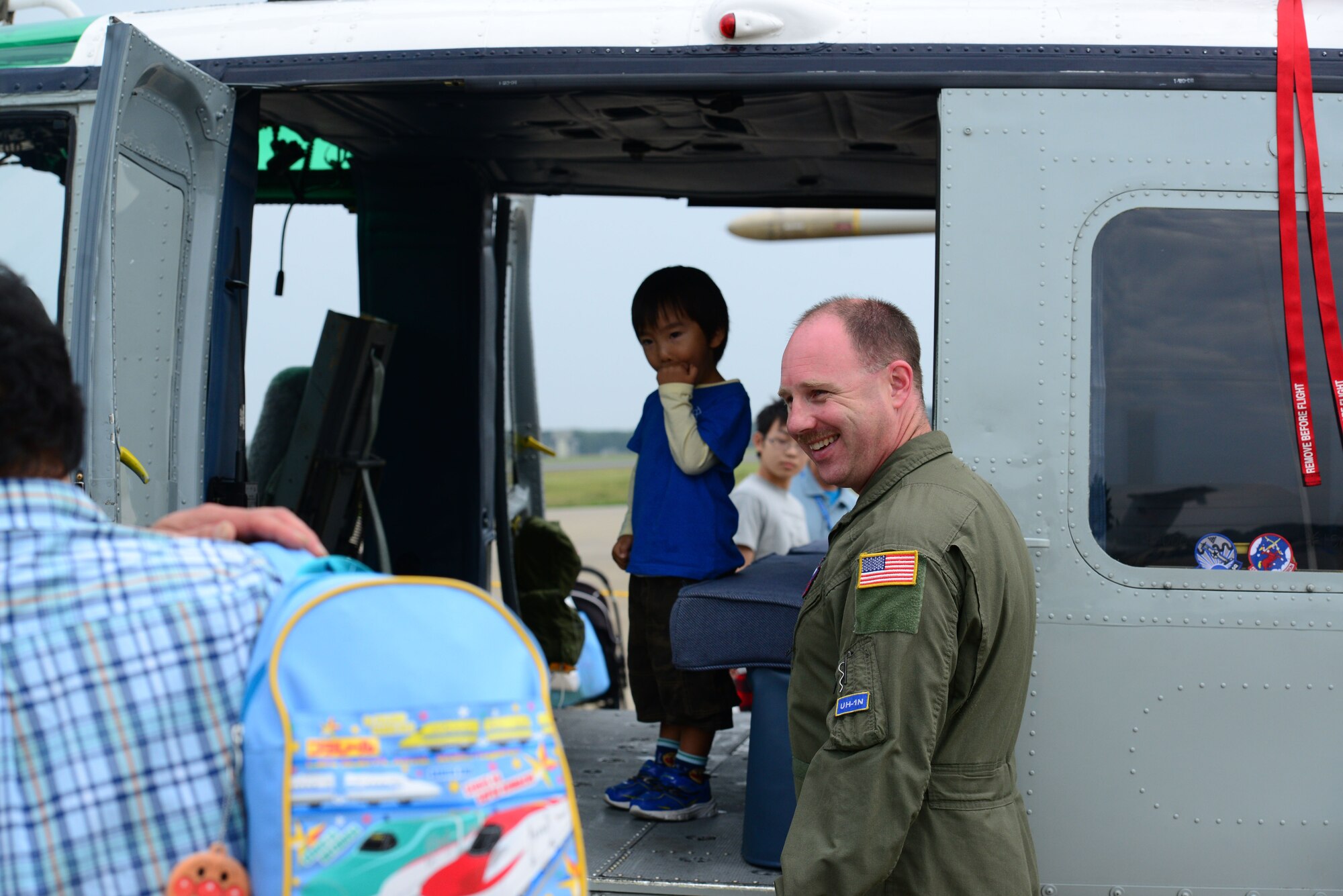 U.S. Air Force Tech. Sgt. David Jacobs interacts with guests at the Misawa Air Festival Sept. 13, 2015. Despite the rainy weather more than 100,000 people came out to the festival to experience the static displays, aerial demonstrations, live music and various types of food. (U.S. Air Force photo by Tech. Sgt. Melissa Mekpongsatorn/Released)