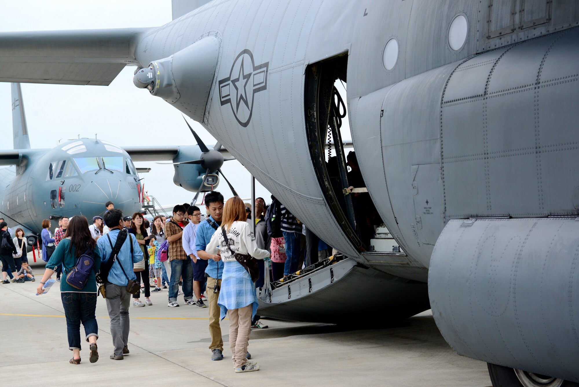 Air Festival attendees wait in line to look inside a C-130 Hercules at Misawa Air Base, Japan, Sept. 13, 2015. The festival featured more than 30 static displays of American, Australian and Japanese aircraft. (U.S. Air Force photo by Tech. Sgt. Melissa Mekpongsatorn/Released) 